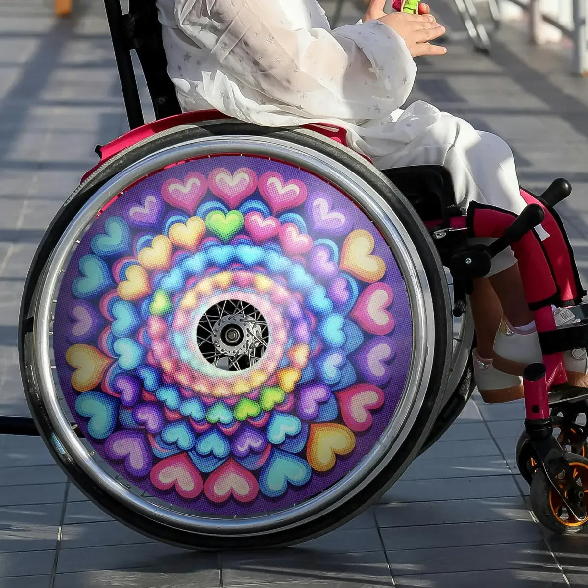 Colorful kids wheelchair spoke guard with spiral rainbow heart pattern