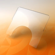 Large transparent wheelchair tray with cut-out, shown on a gradient orange background