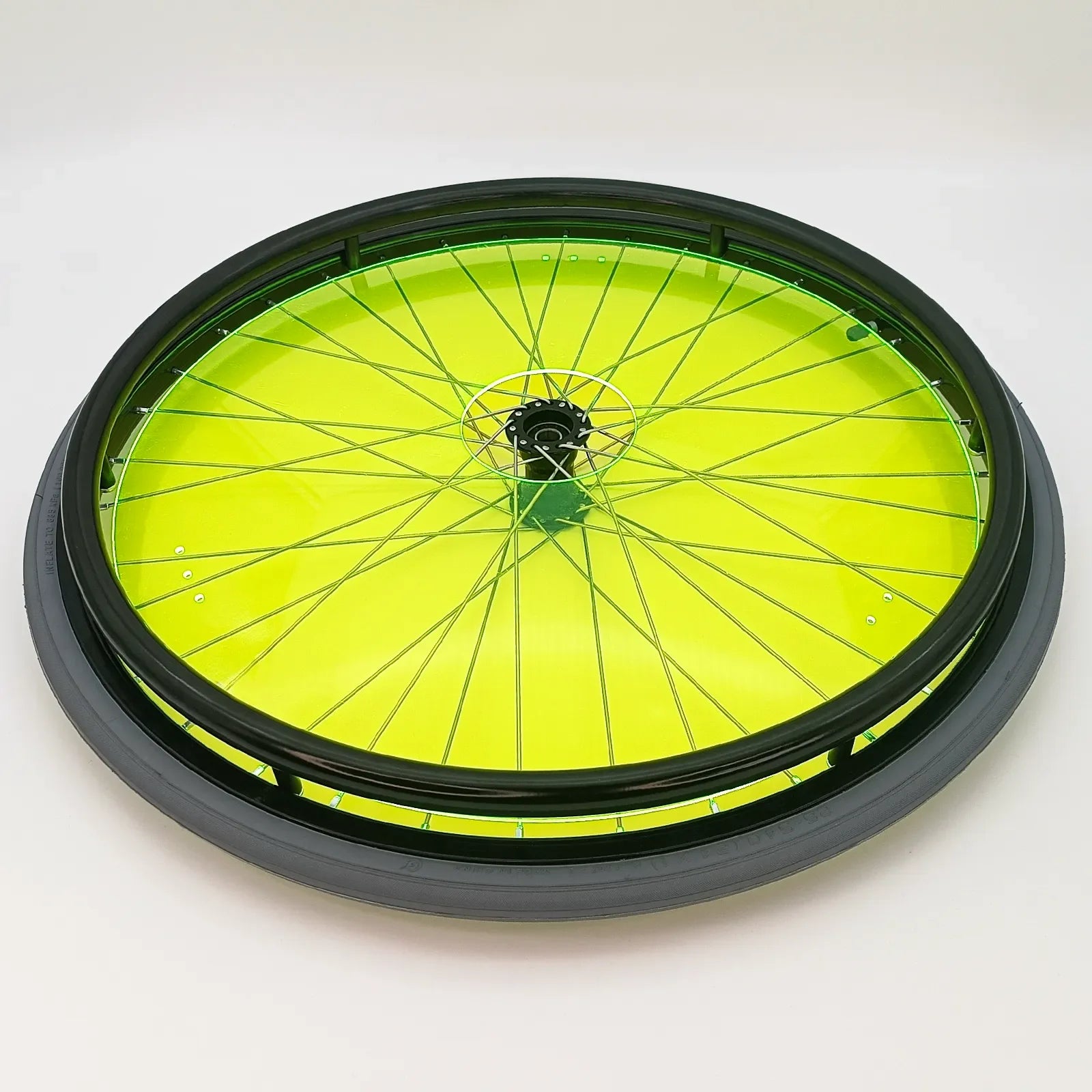 Bright green wheelchair spoke guard with black rim and tire, durable wheelchair accessory for safety and style