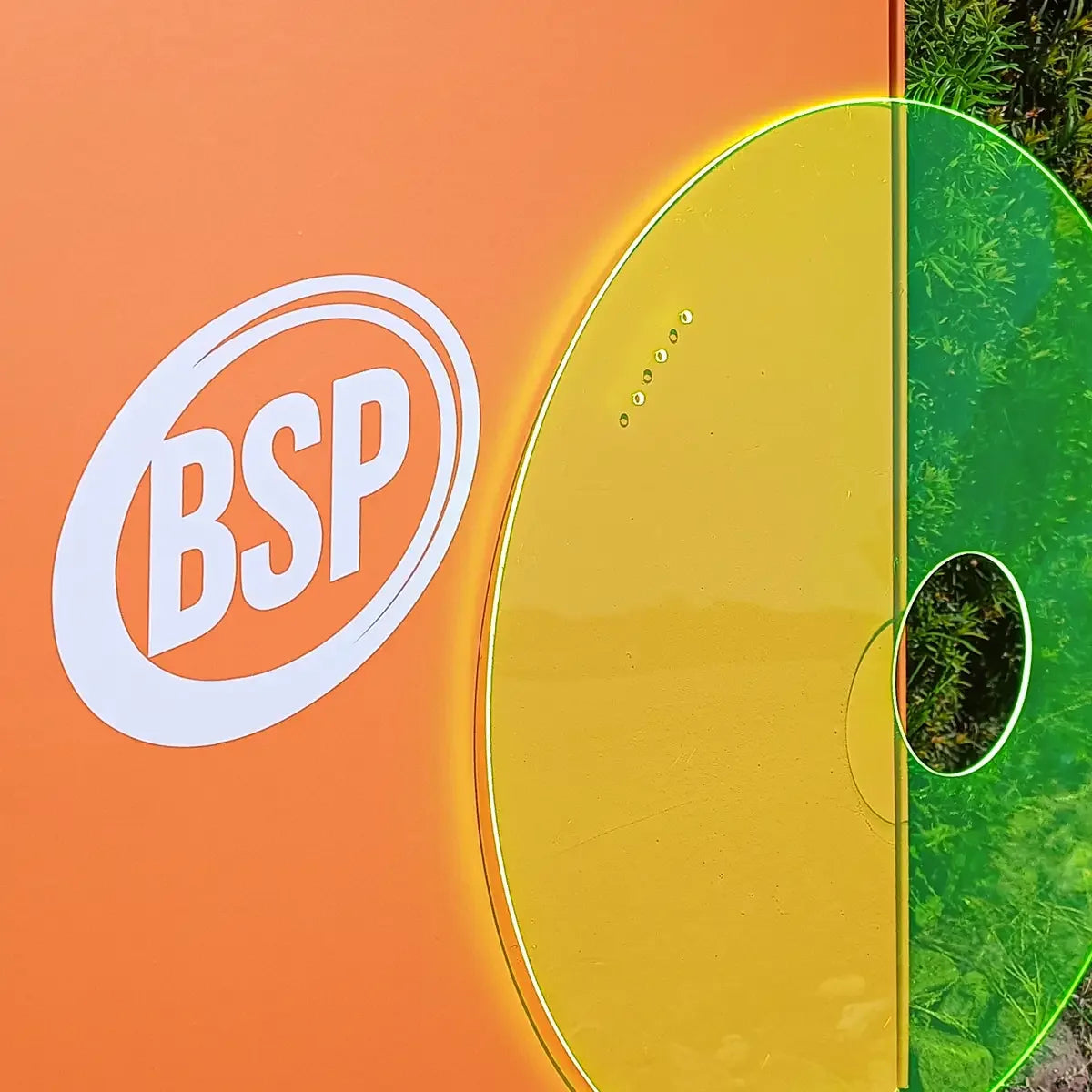 BSP logo on orange background with yellow and green translucent wheelchair spoke guards