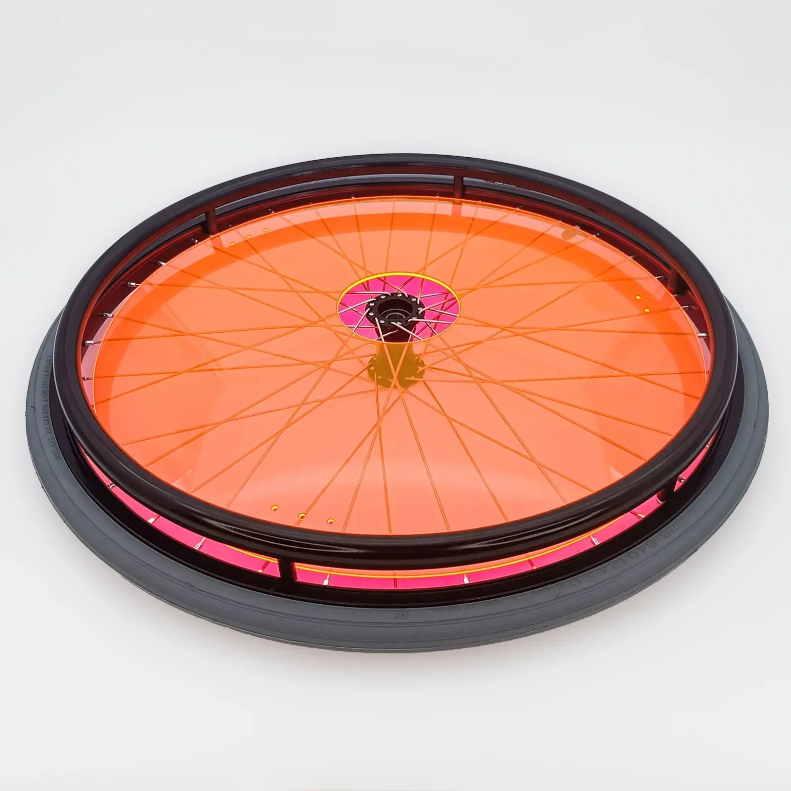 Bright orange wheelchair spoke guard with pink accents, durable wheel protection for mobility users