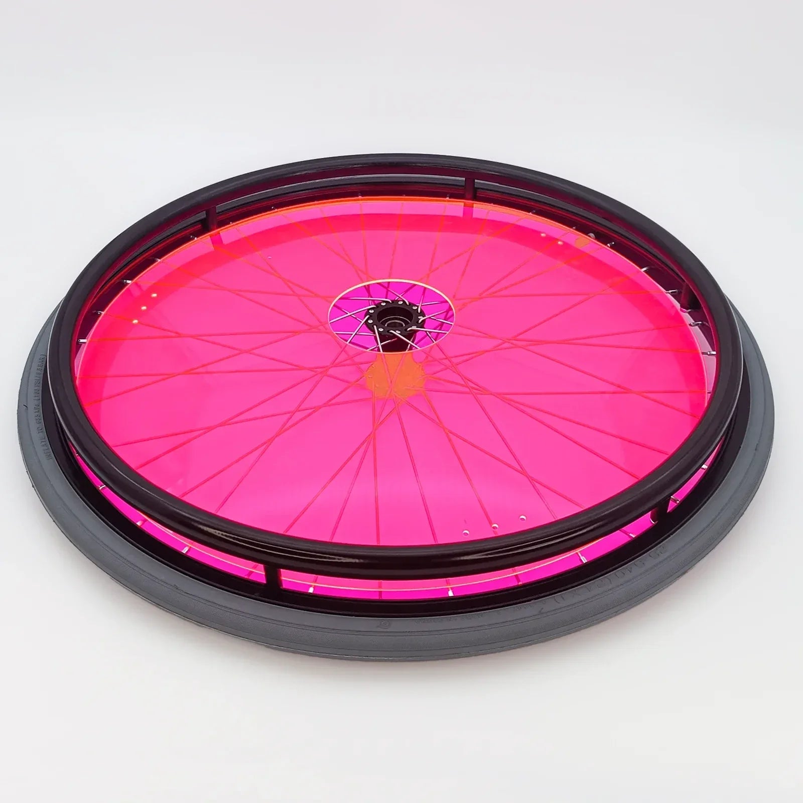 Bright pink wheelchair spoke guard with black rim and tire, durable wheelchair accessory for safety and style