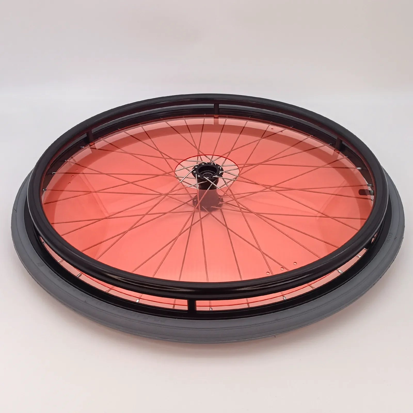 Red transparent wheelchair spoke guard with black rim and tire, durable wheelchair accessory for safety and style