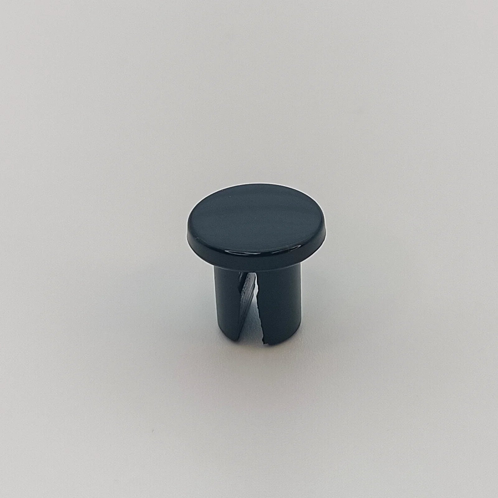 Black plastic snap-in cap for wheelchair parts, durable accessory for mobility equipment