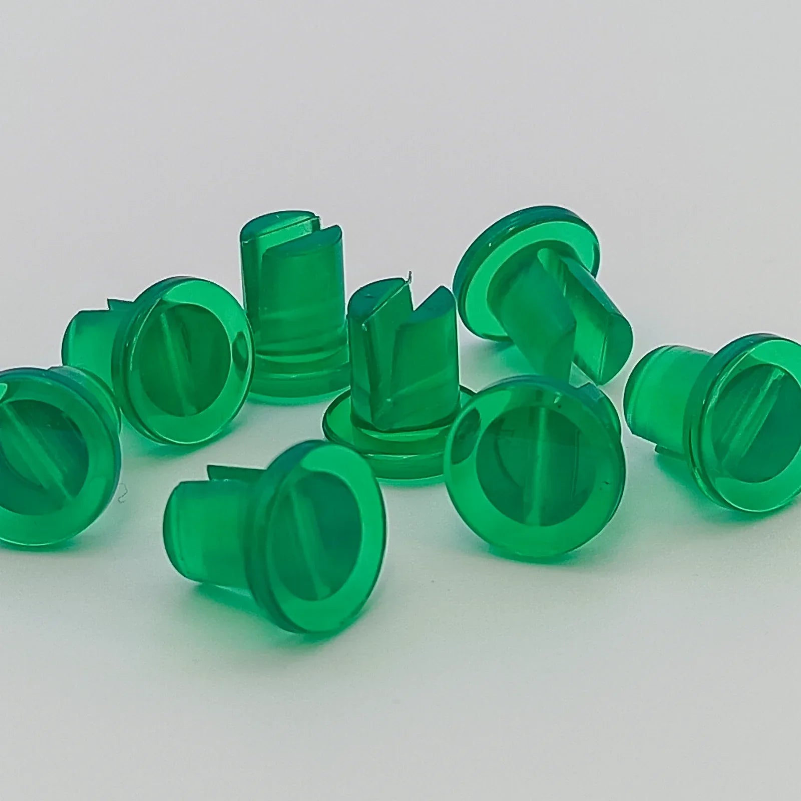 Green plastic wheelchair spoke guards for safety and durability