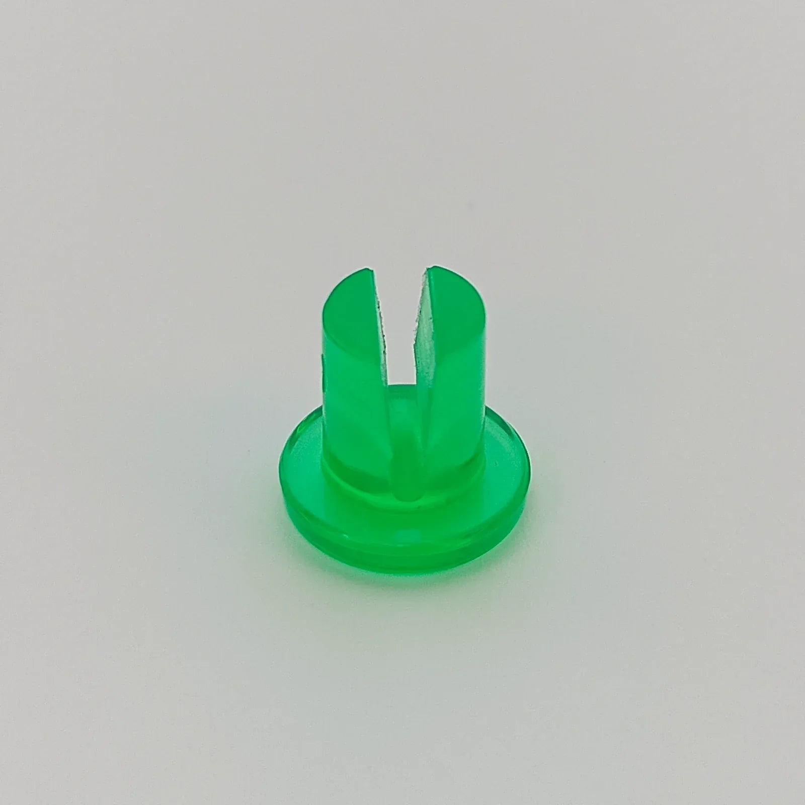 Green plastic wheelchair spoke guard clip for secure wheel attachment