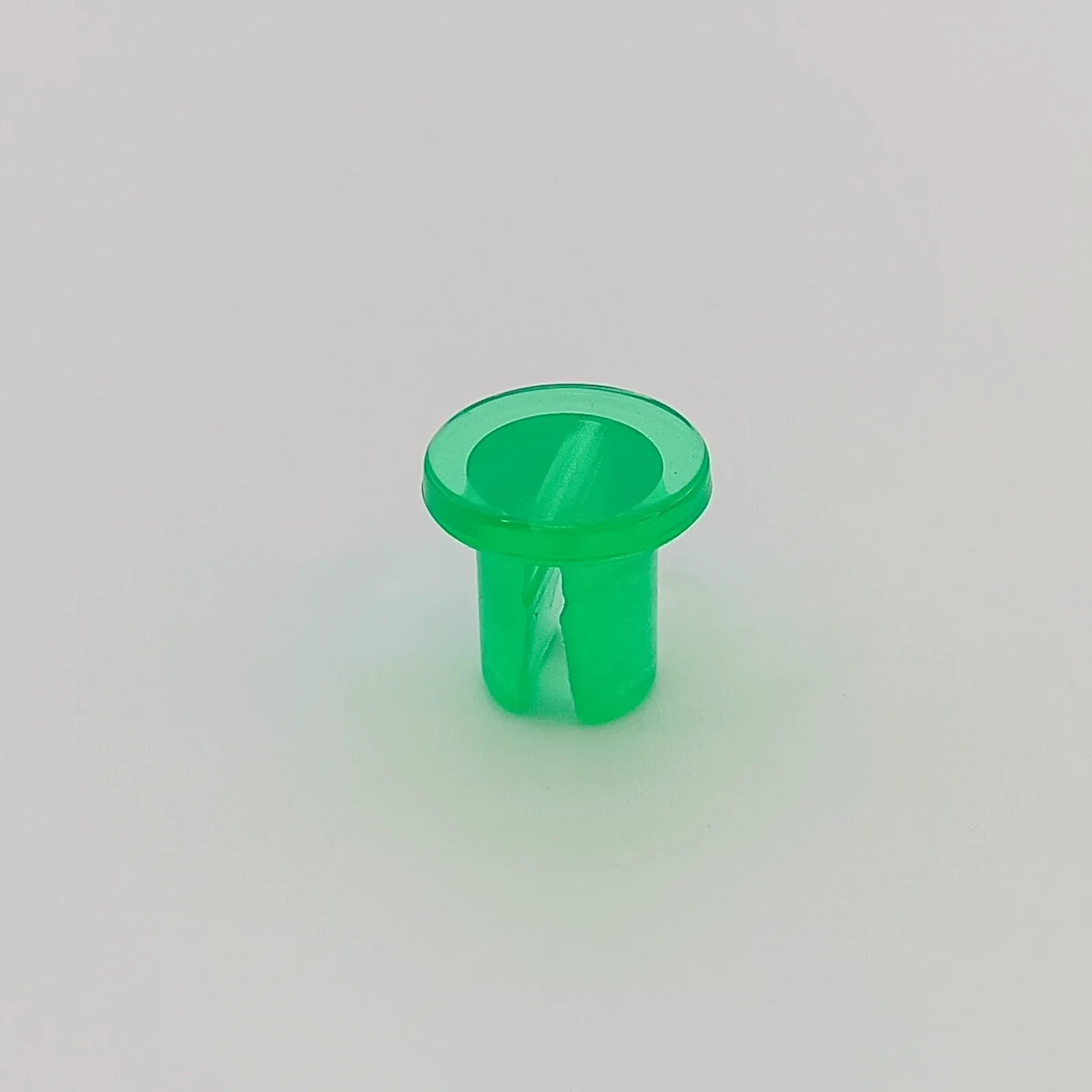 Green plastic wheelchair spoke guard cap for secure wheel protection