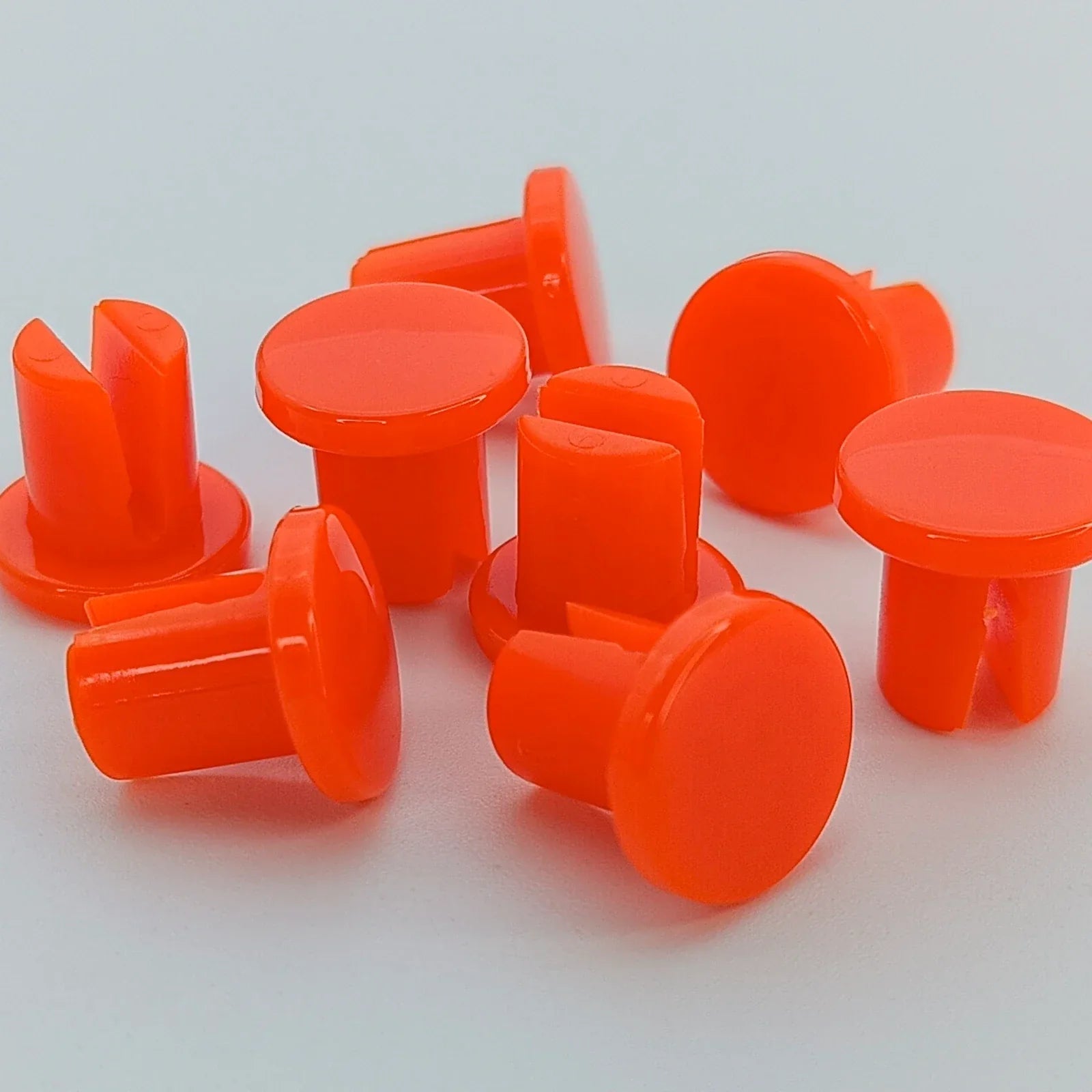 Bright orange wheelchair spoke guards for safety and durability