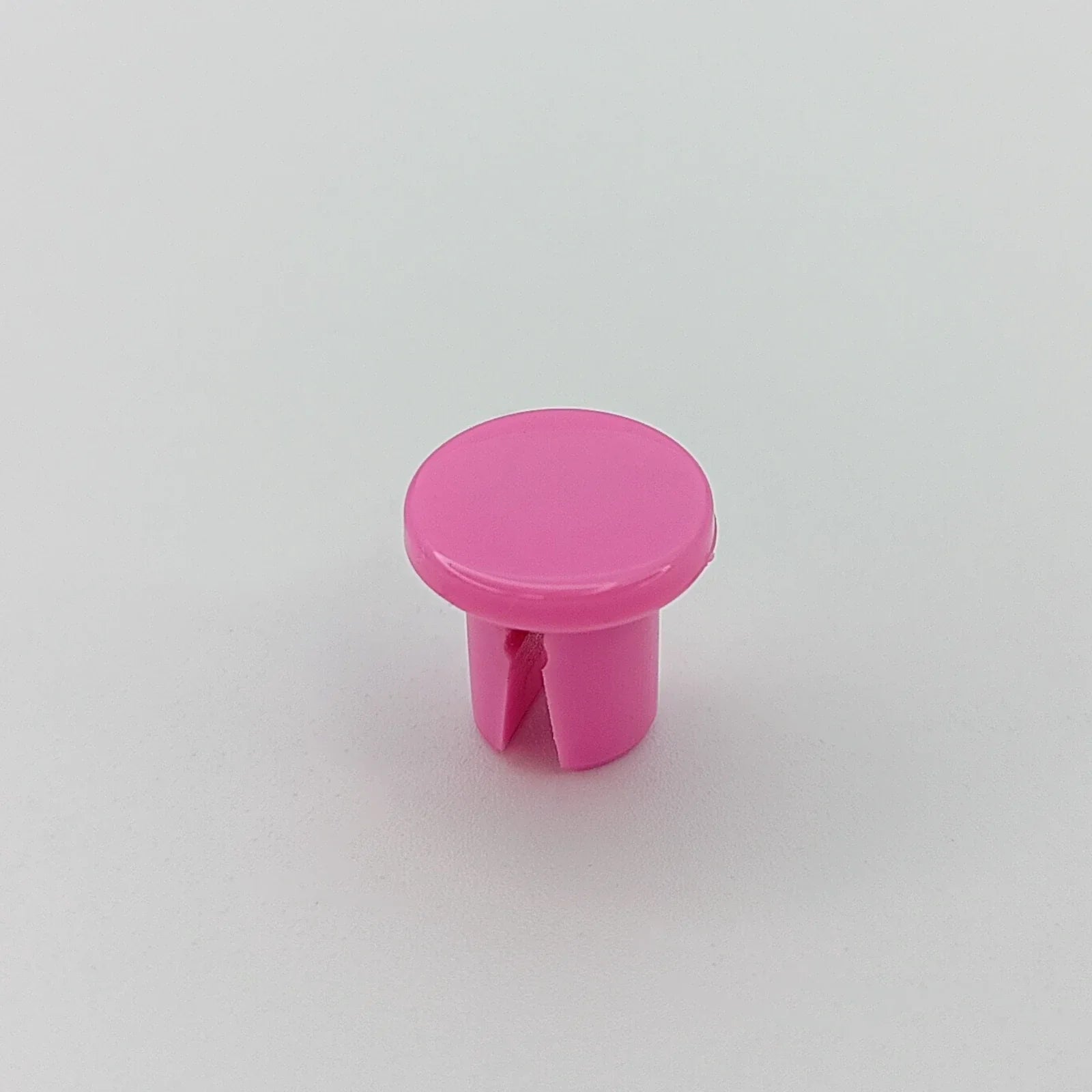 Pink plastic wheelchair spoke guard cap for wheel safety and customization