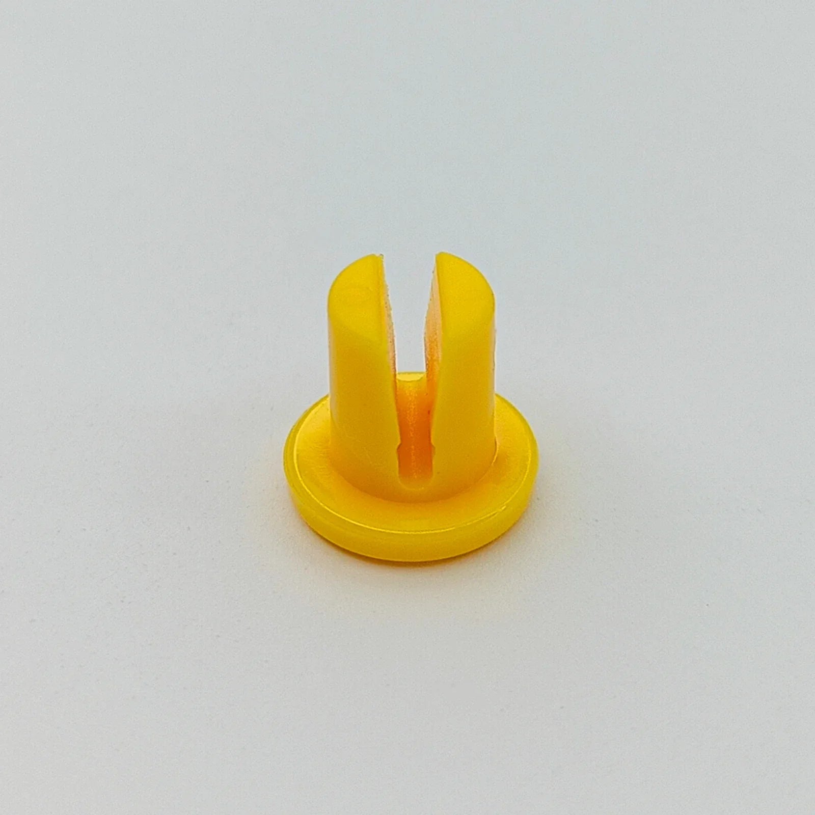 Yellow plastic wheelchair spoke guard clip for secure wheel attachment
