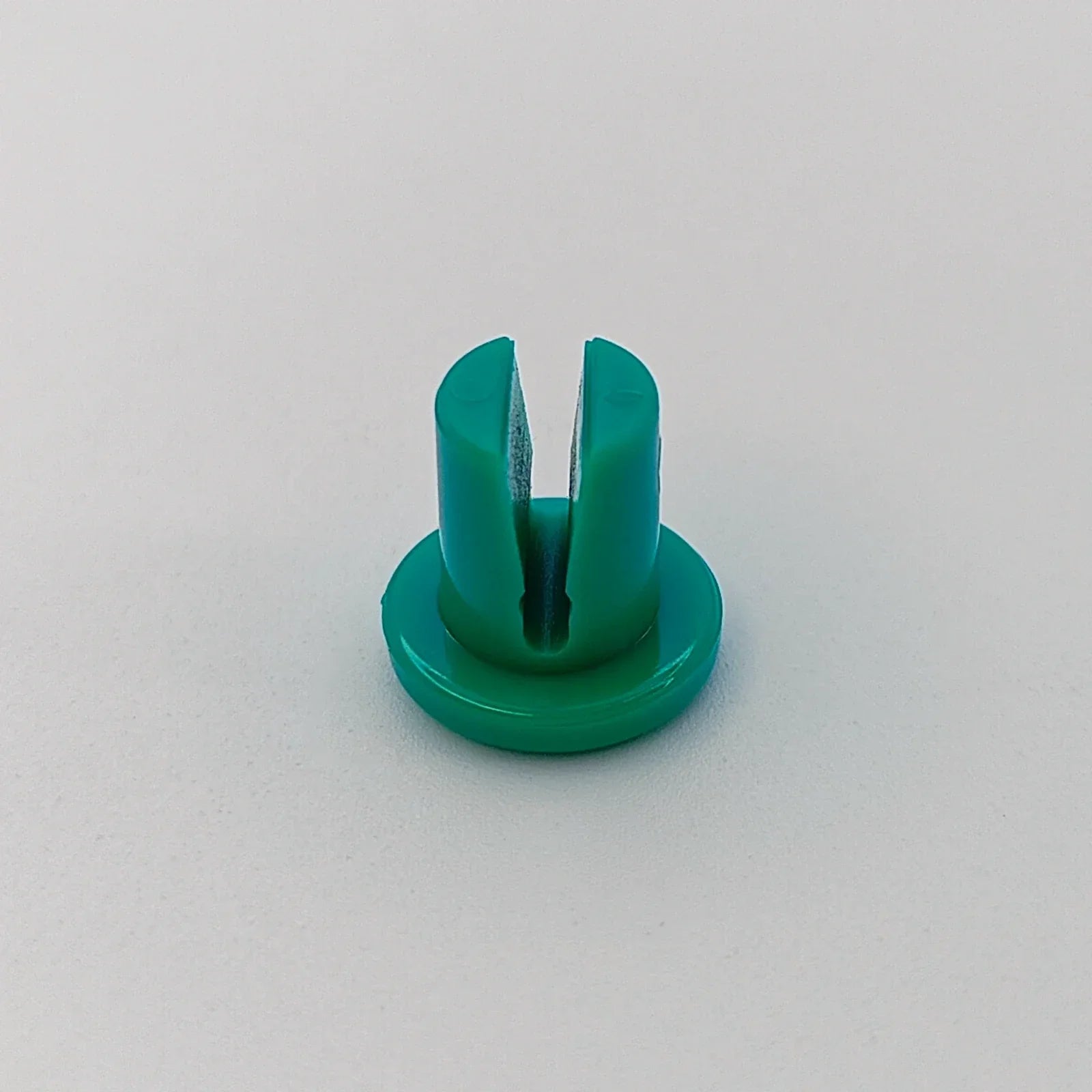 Green plastic wheelchair spoke guard for wheel safety and protection