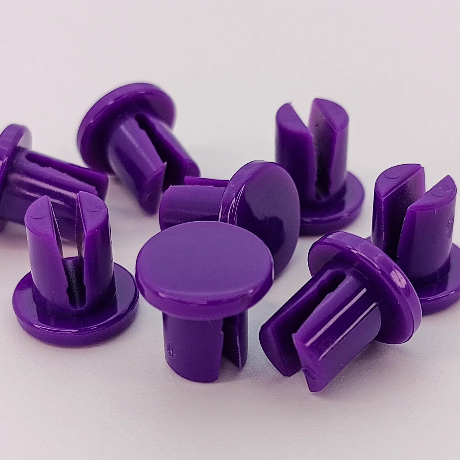 Purple plastic wheelchair accessory clips for secure attachment and customization