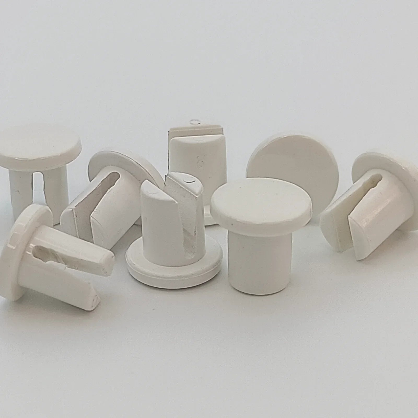 White plastic wheelchair spoke guards and tray mounts for durable mobility accessories