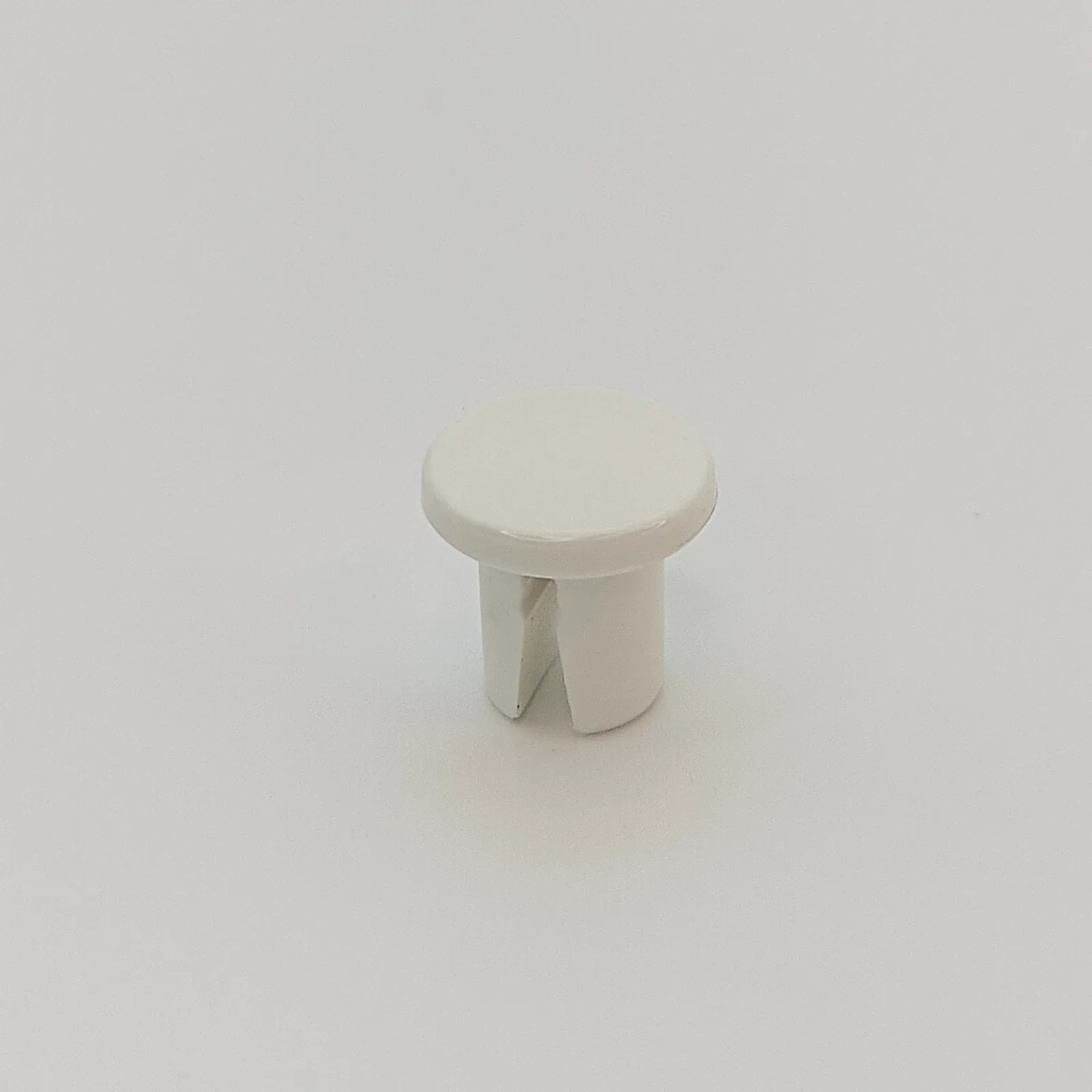 White plastic wheelchair accessory cap for spoke guards or trays, durable and customizable part