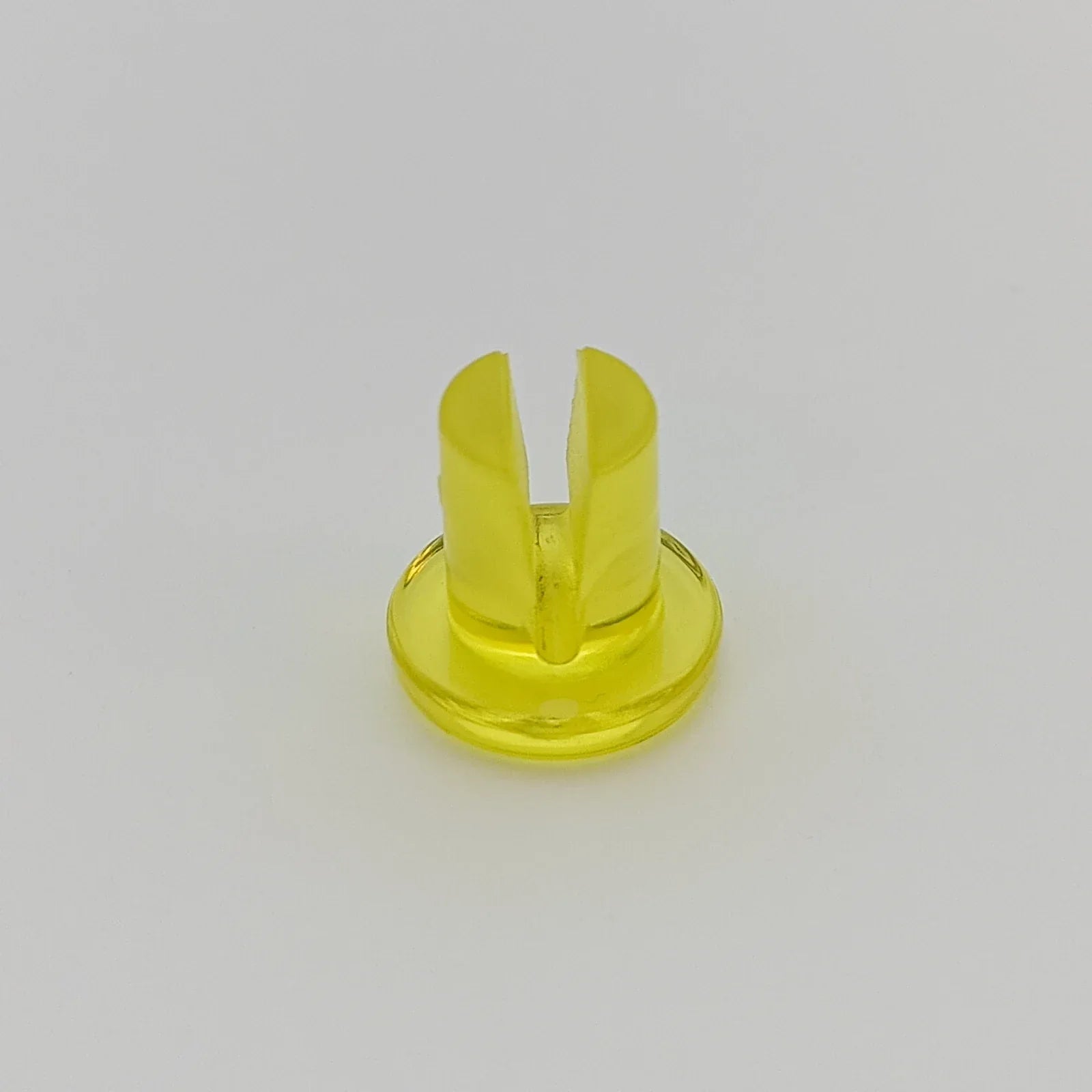 Yellow plastic wheelchair spoke guard clip for secure wheel attachment