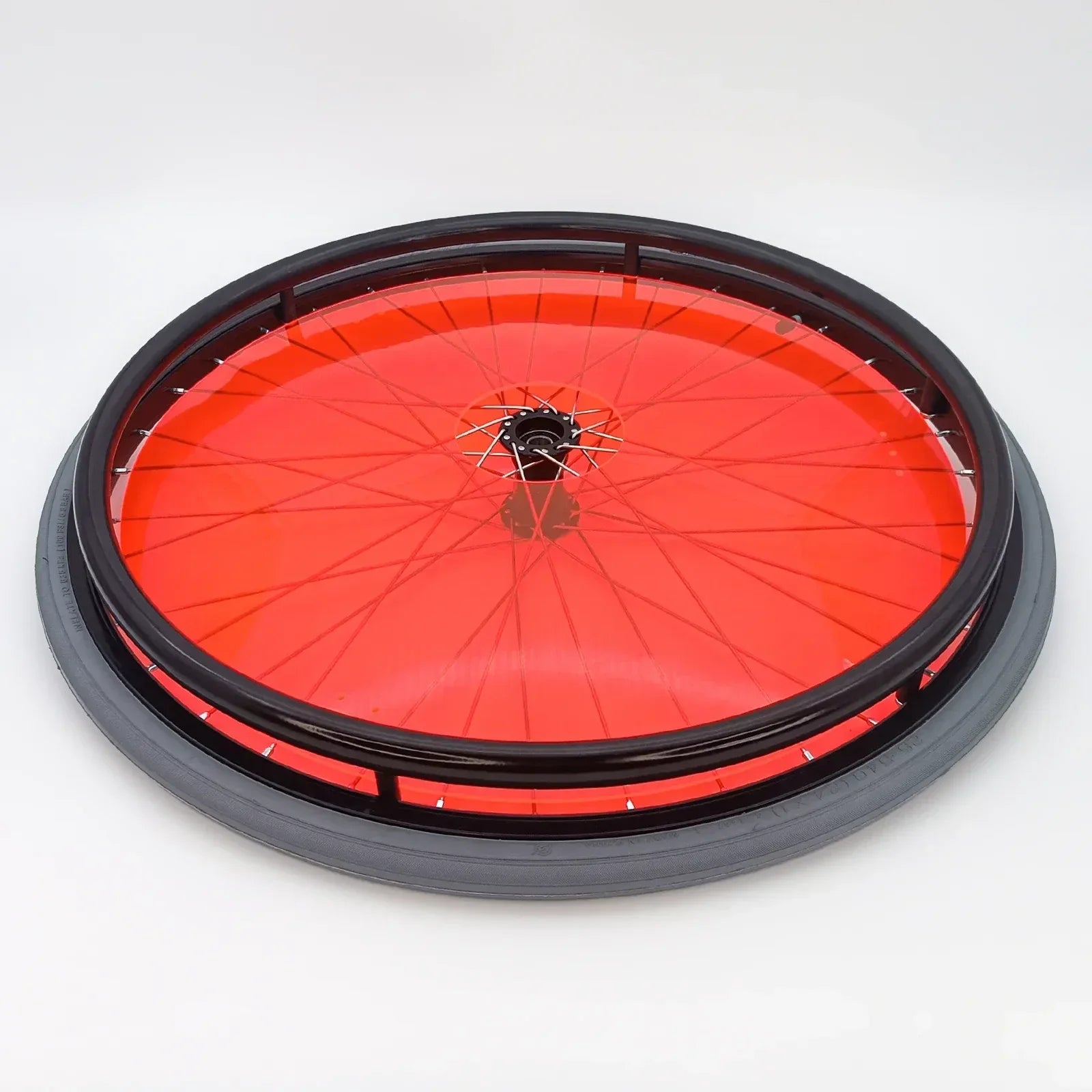 Red wheelchair wheel with black tire and spoke guard for mobility accessories