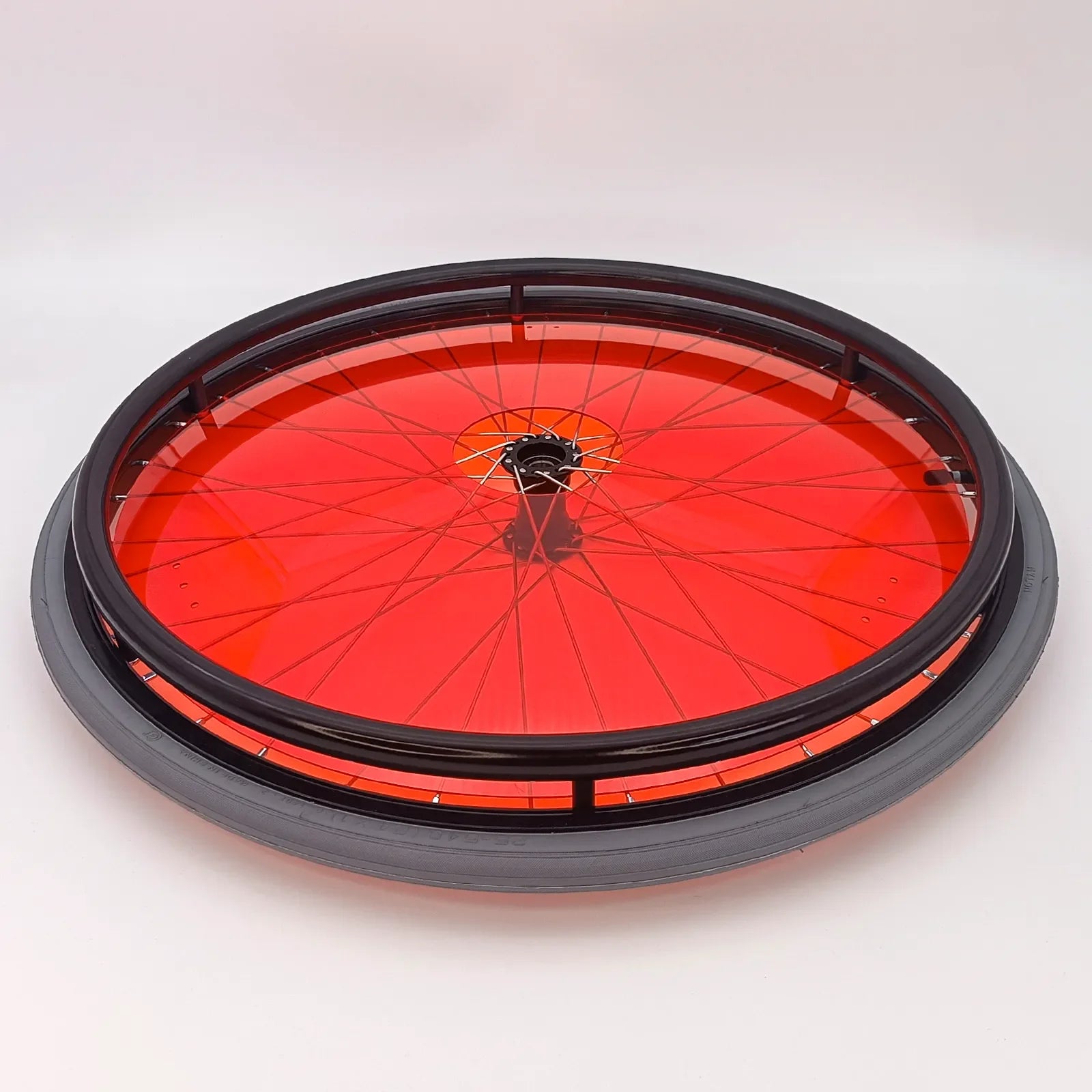 Red wheelchair wheel with black rim and spokes, durable accessory for mobility