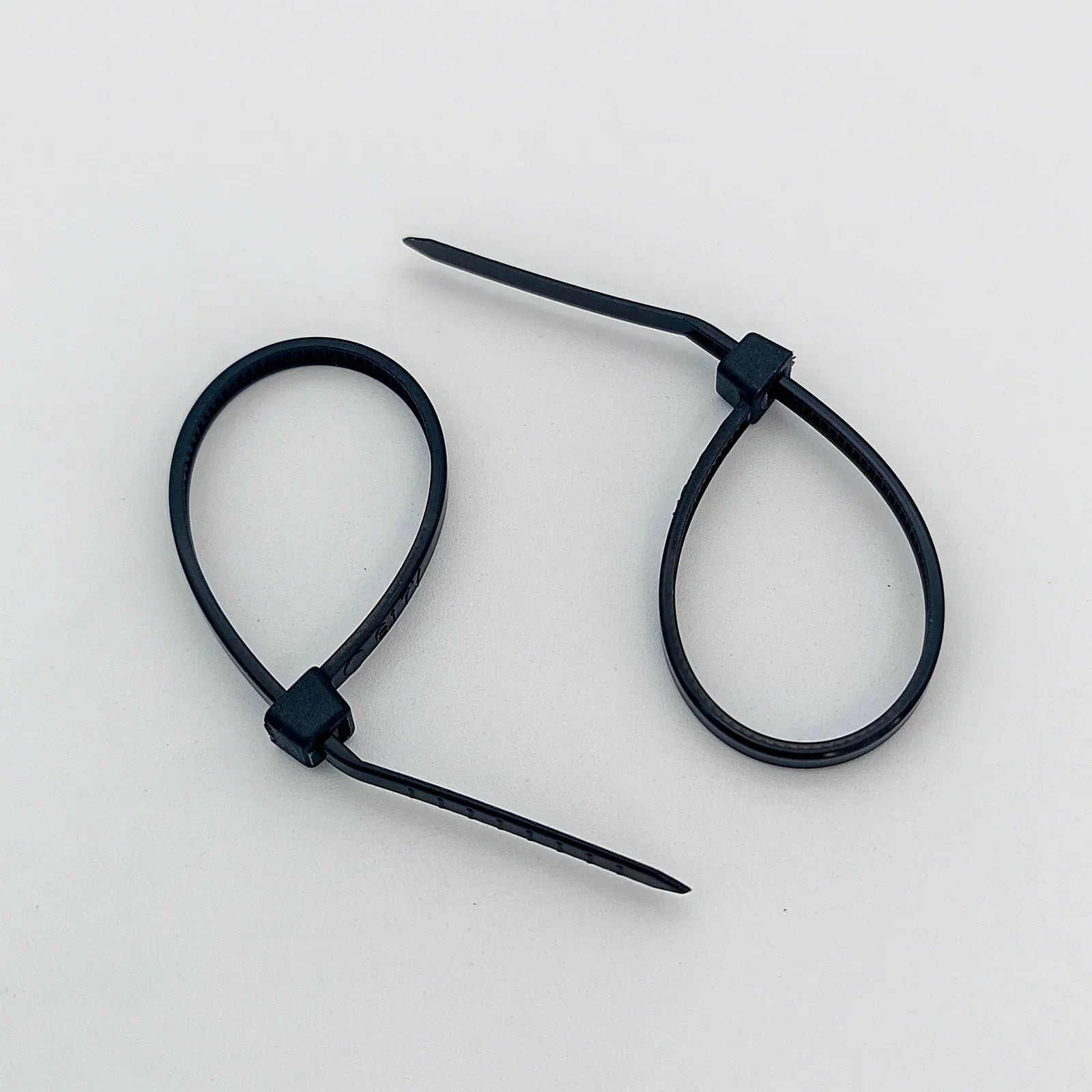 Black plastic cable ties for wheelchair accessories and parts organization