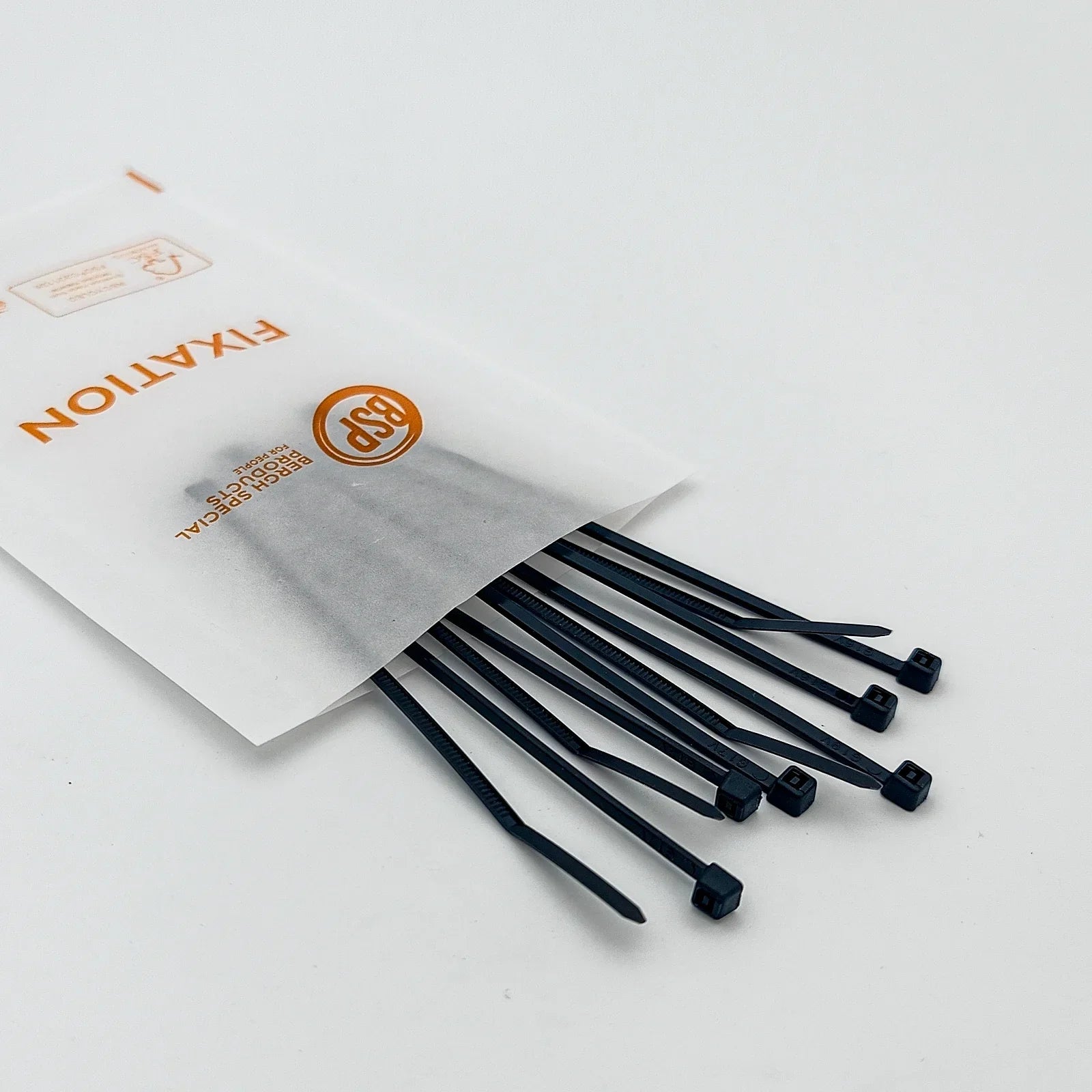Black plastic cable ties for wheelchair accessories, spilling from a labeled package on white background