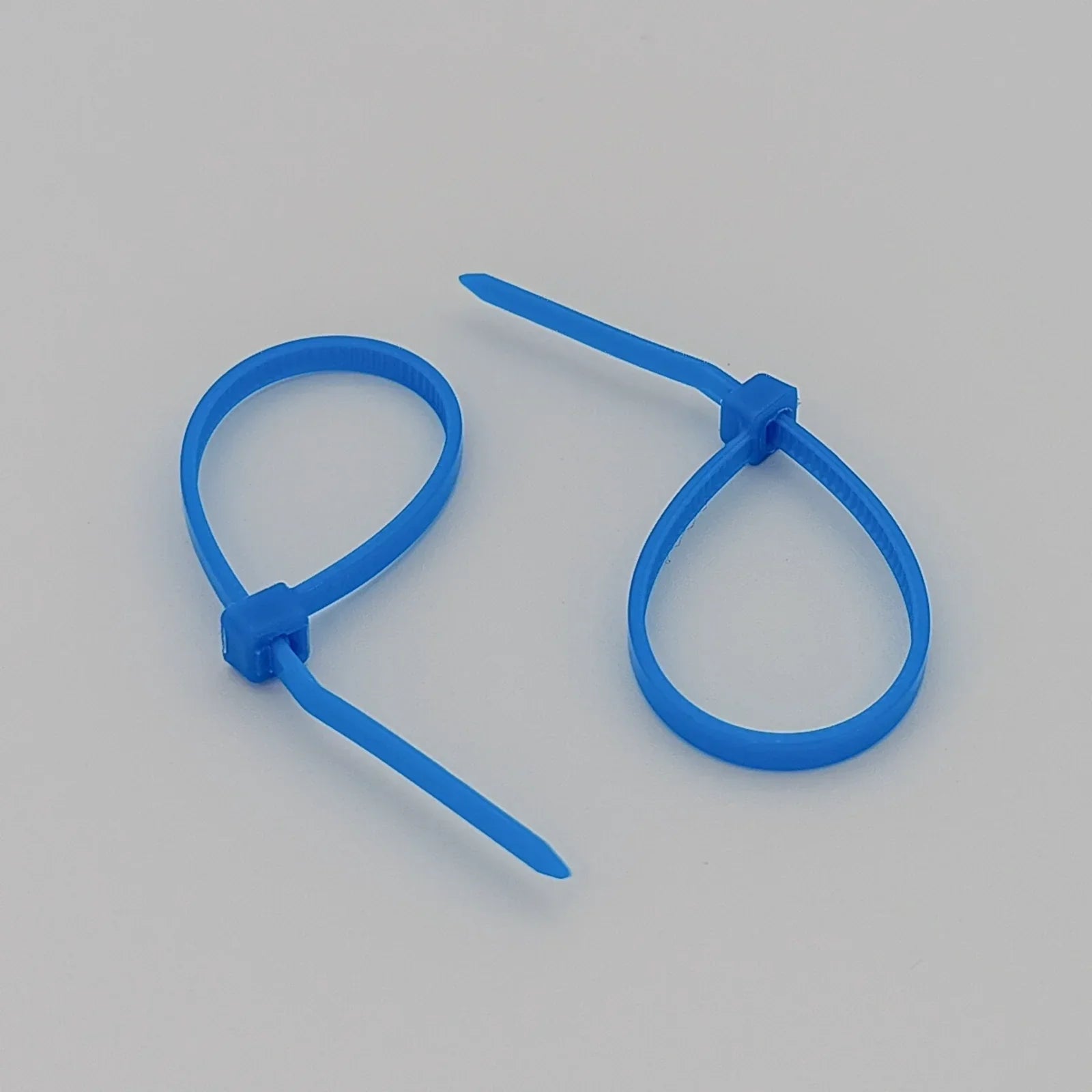 Blue plastic cable ties for wheelchair accessories and parts organization