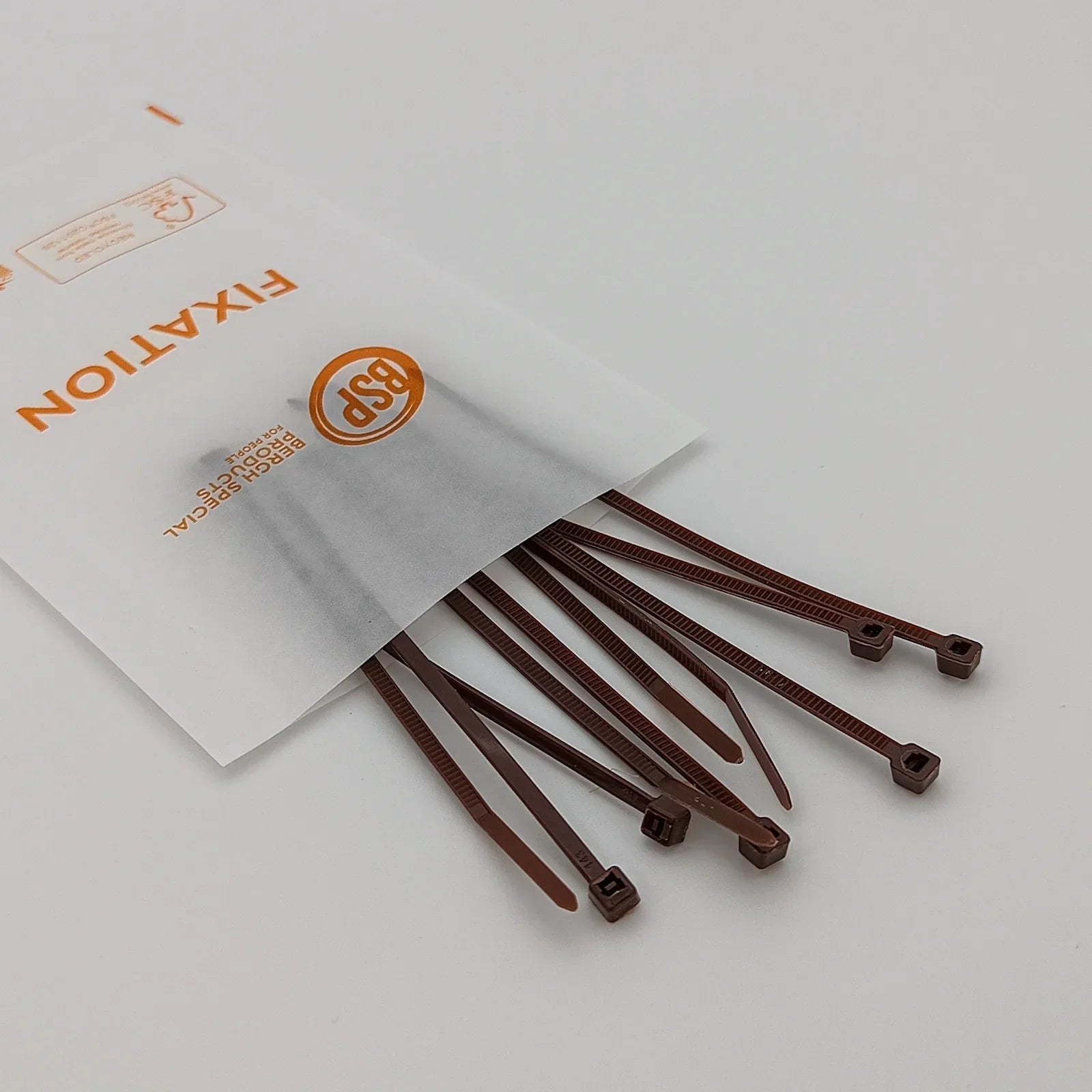Brown plastic cable ties for wheelchair accessories, spilling from a BSP fixation pack