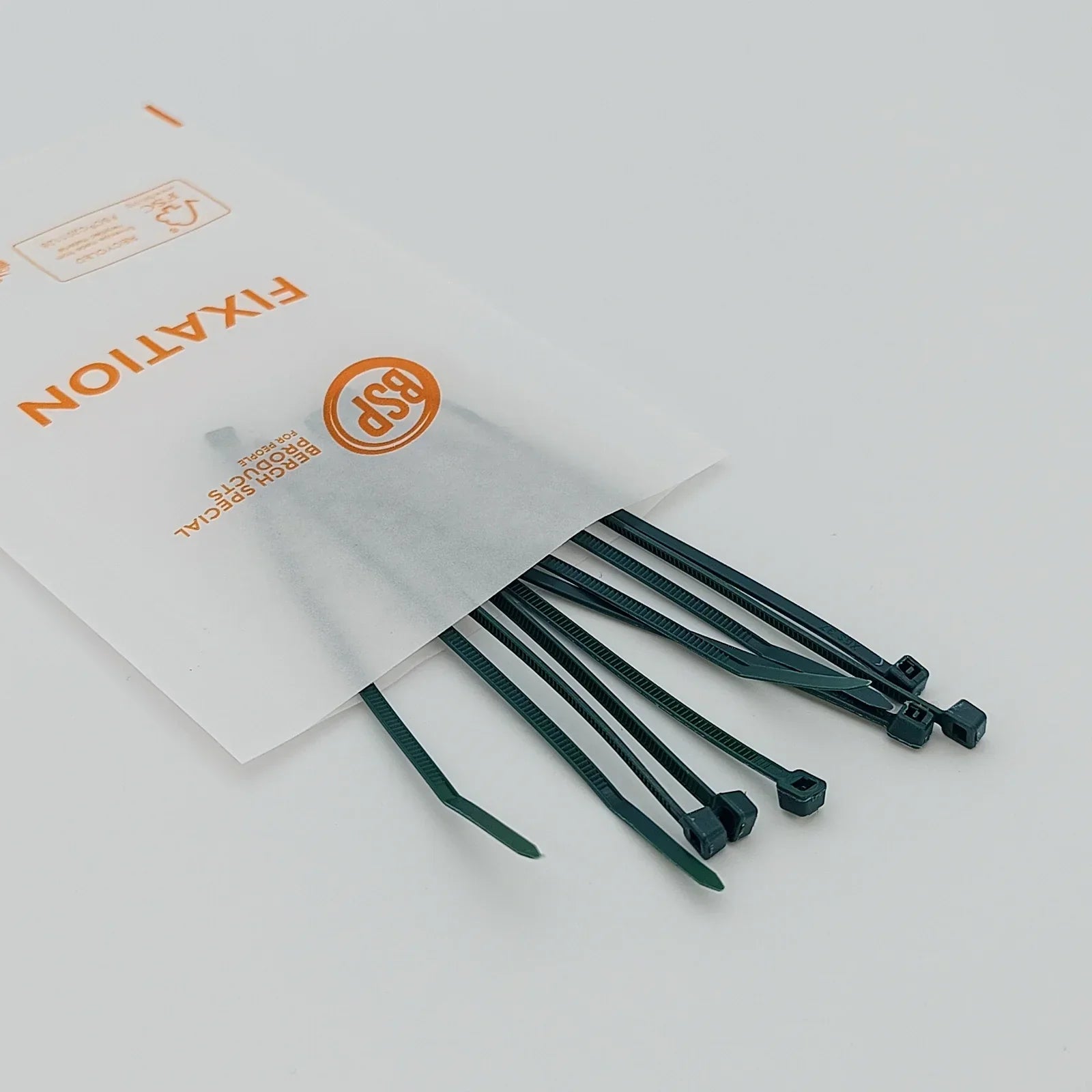 Green cable ties for wheelchair accessories, packaged in Bergh Special Products fixation bag