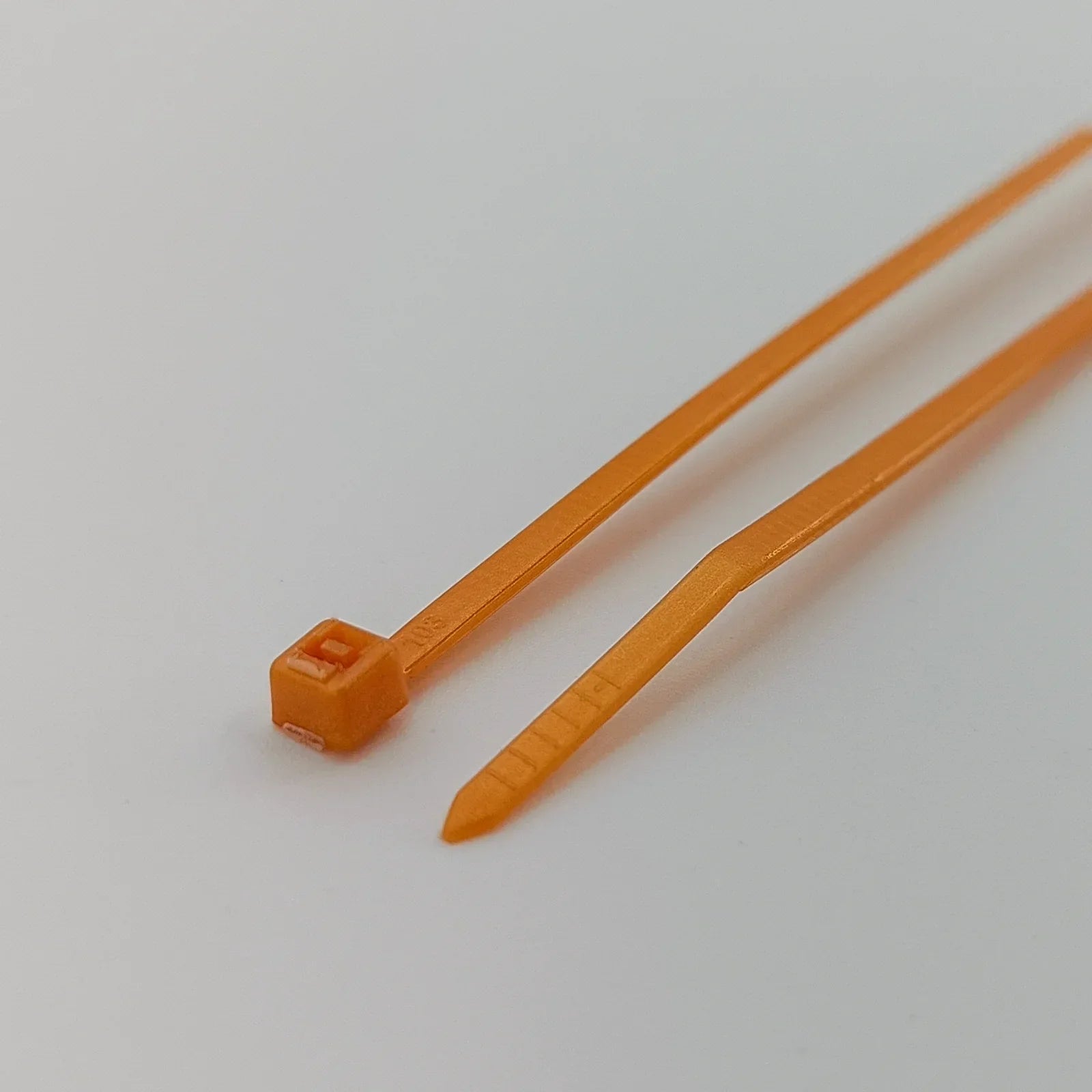 Orange plastic cable ties for wheelchair accessories and durable equipment organization