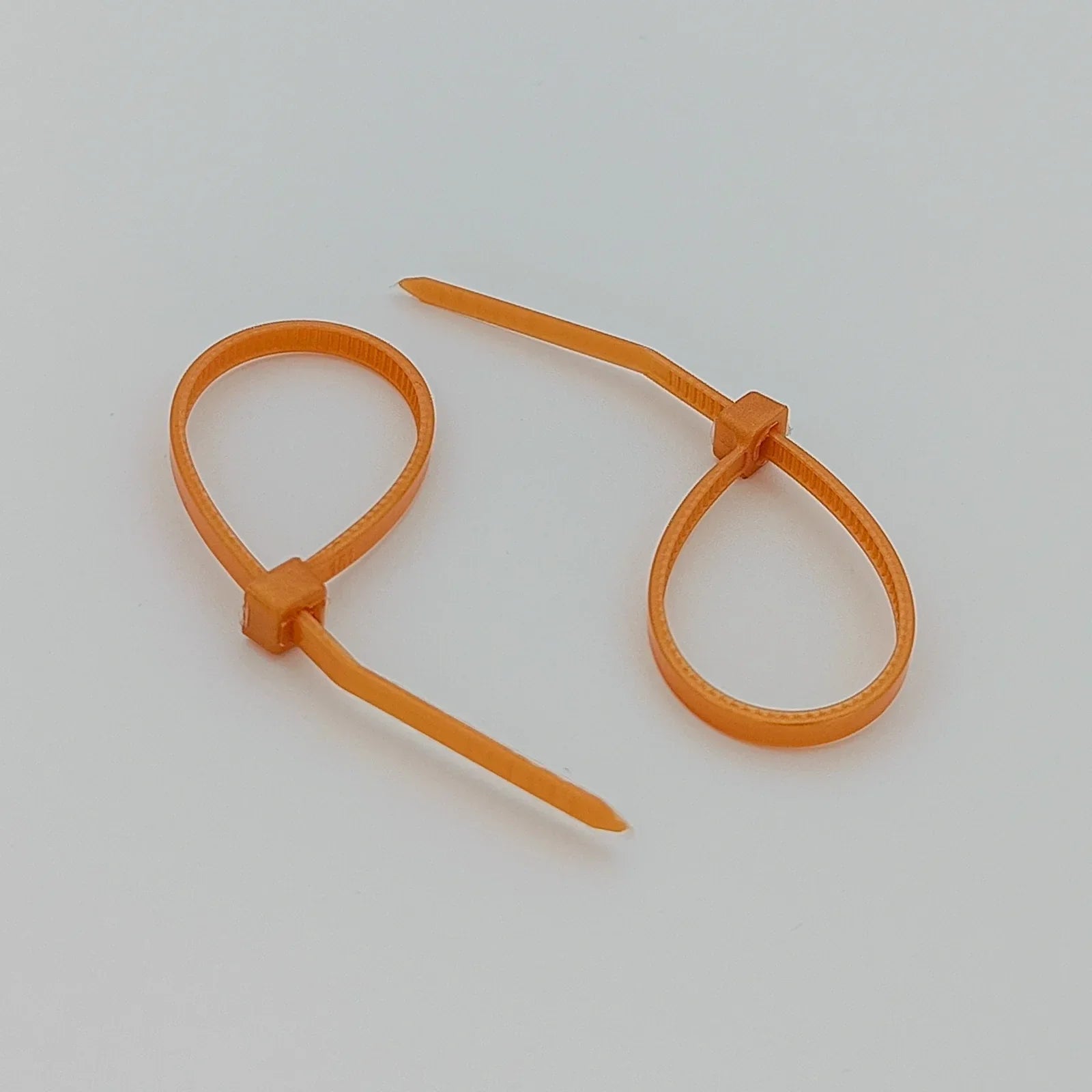 Orange plastic cable ties for wheelchair accessories and parts organization