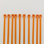 Orange plastic cable ties for wheelchair accessories and parts organization