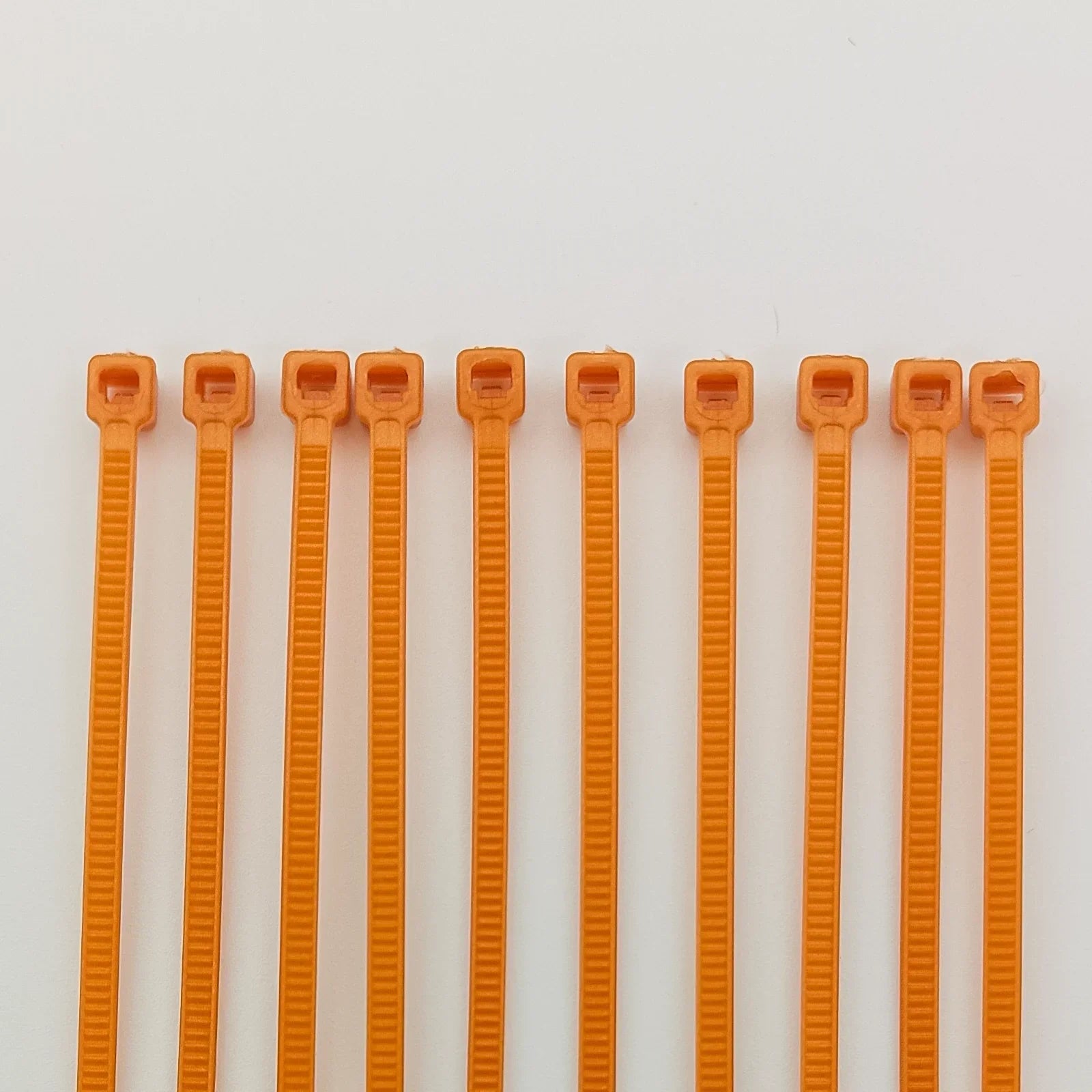 Orange plastic cable ties for wheelchair accessories and parts organization