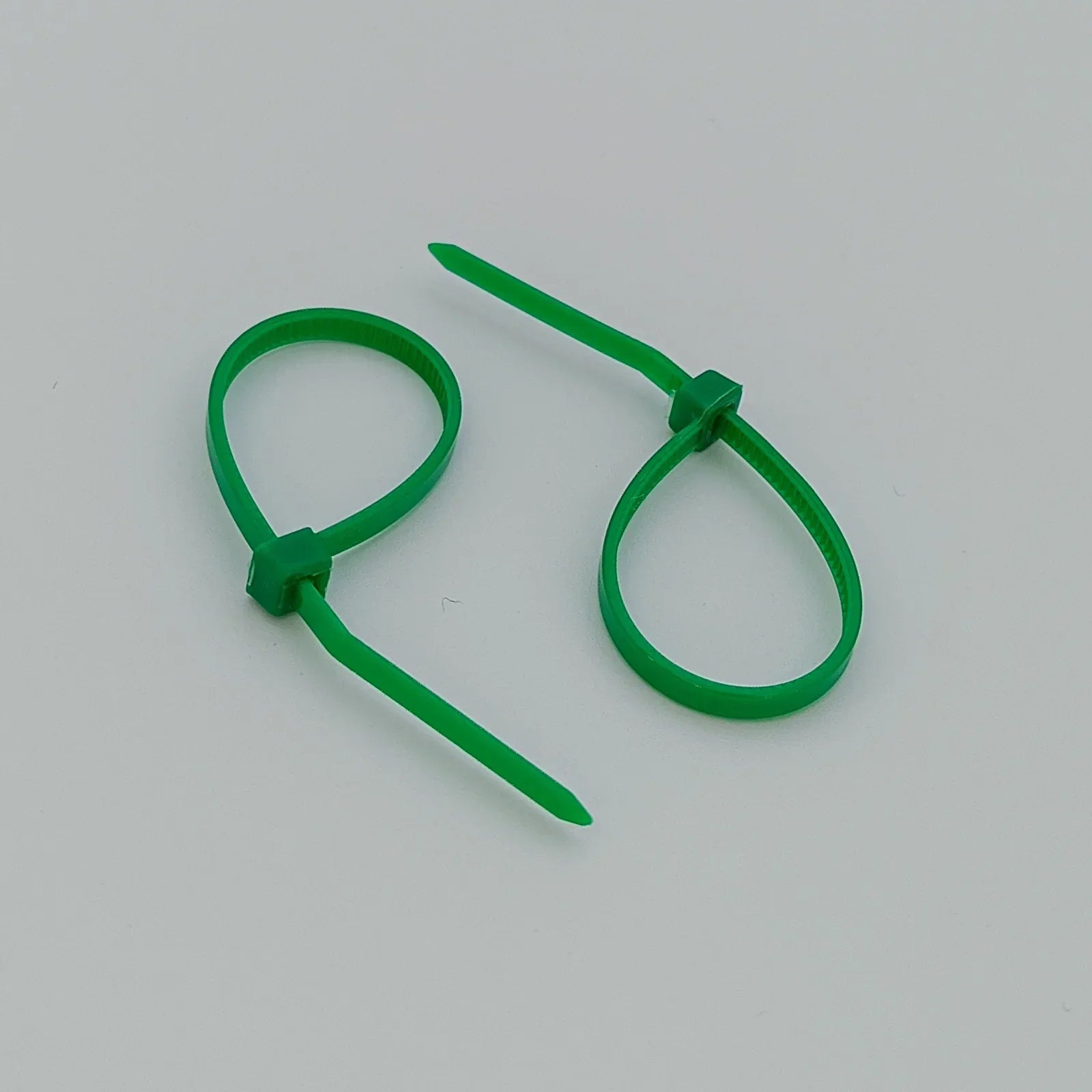 Green plastic cable ties for wheelchair accessories and parts organization