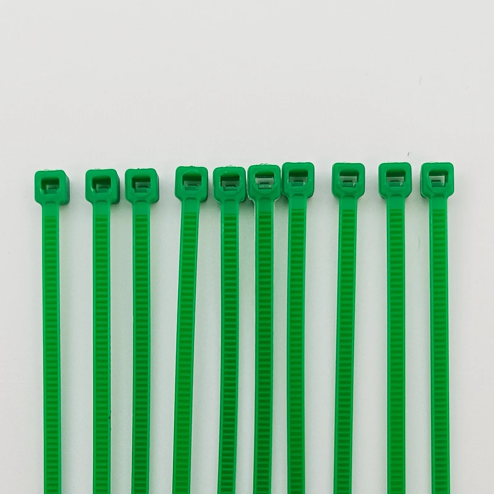 Green plastic cable ties for wheelchair accessories and parts organization
