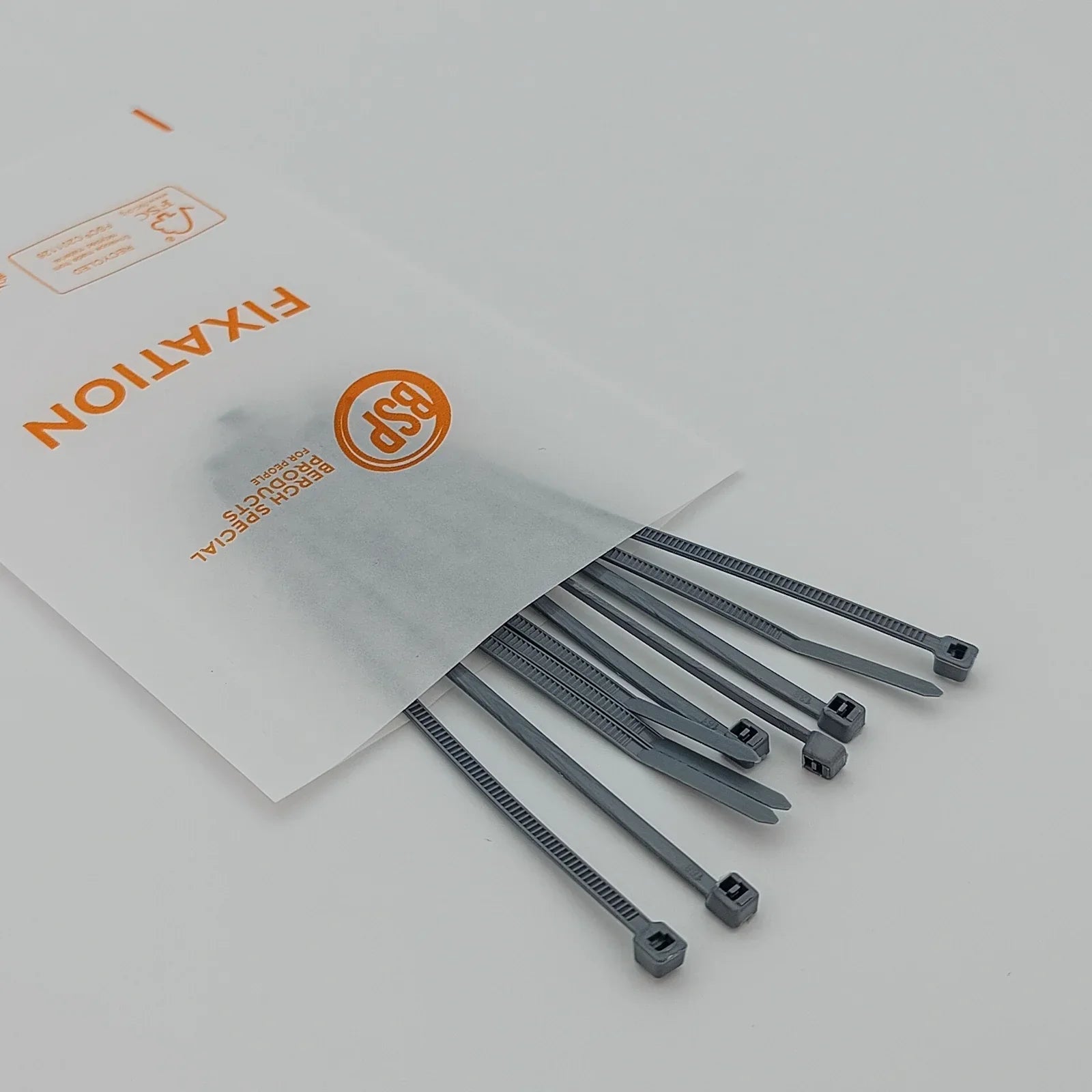 Gray plastic cable ties for wheelchair accessory fixation, packaged in clear BSP-labeled bag