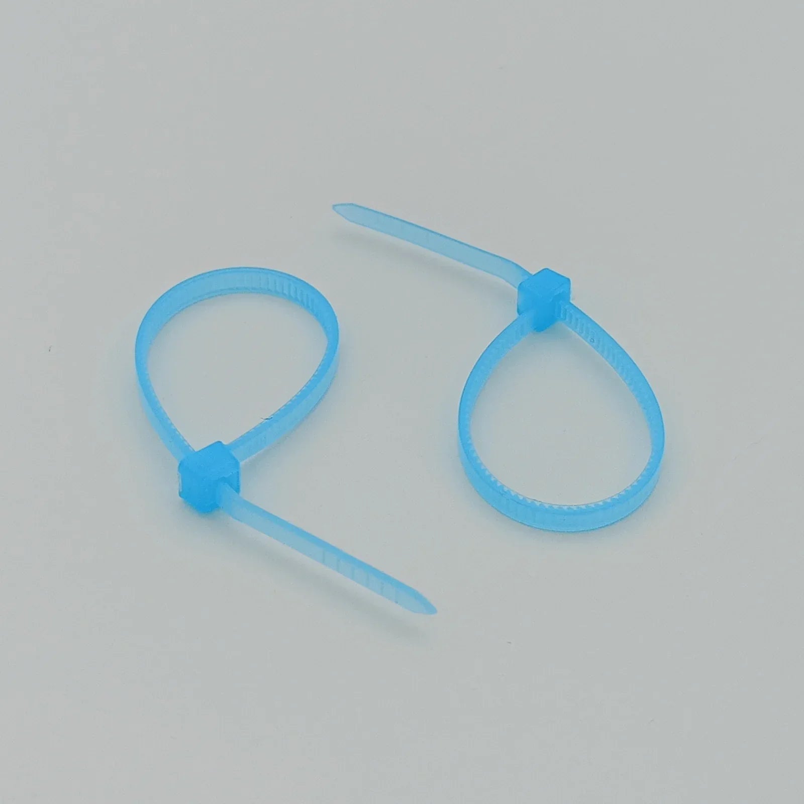 Light blue plastic cable ties for wheelchair accessories and durable parts organization