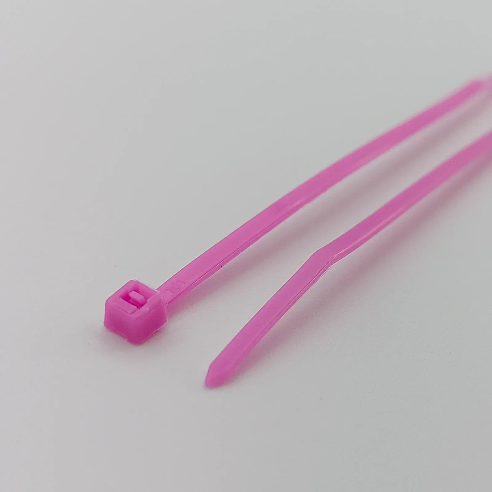 Pink plastic cable ties for wheelchair accessories and equipment organization