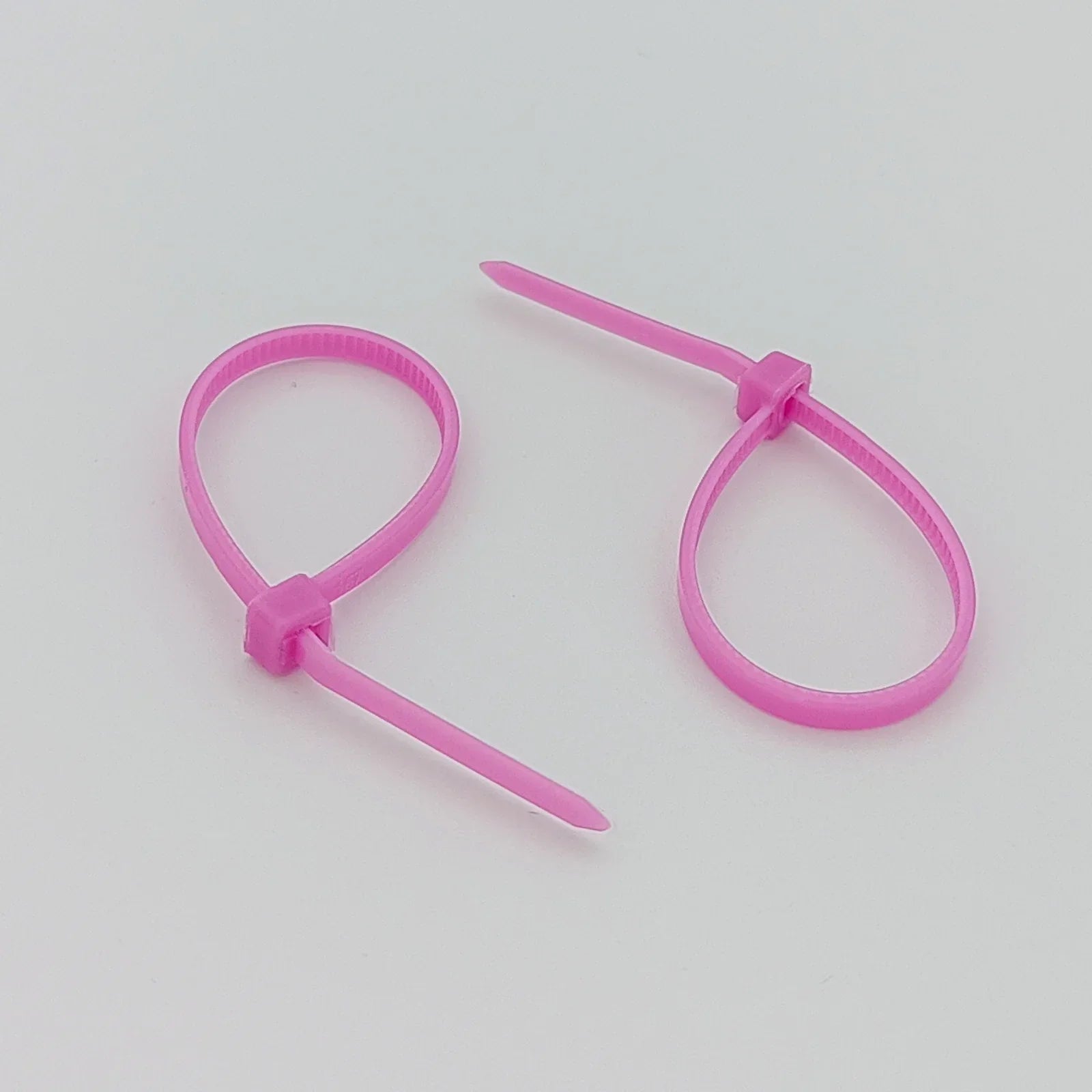 Pink plastic cable ties for wheelchair accessories and parts organization