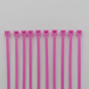Pink plastic cable ties for wheelchair accessories and parts organization