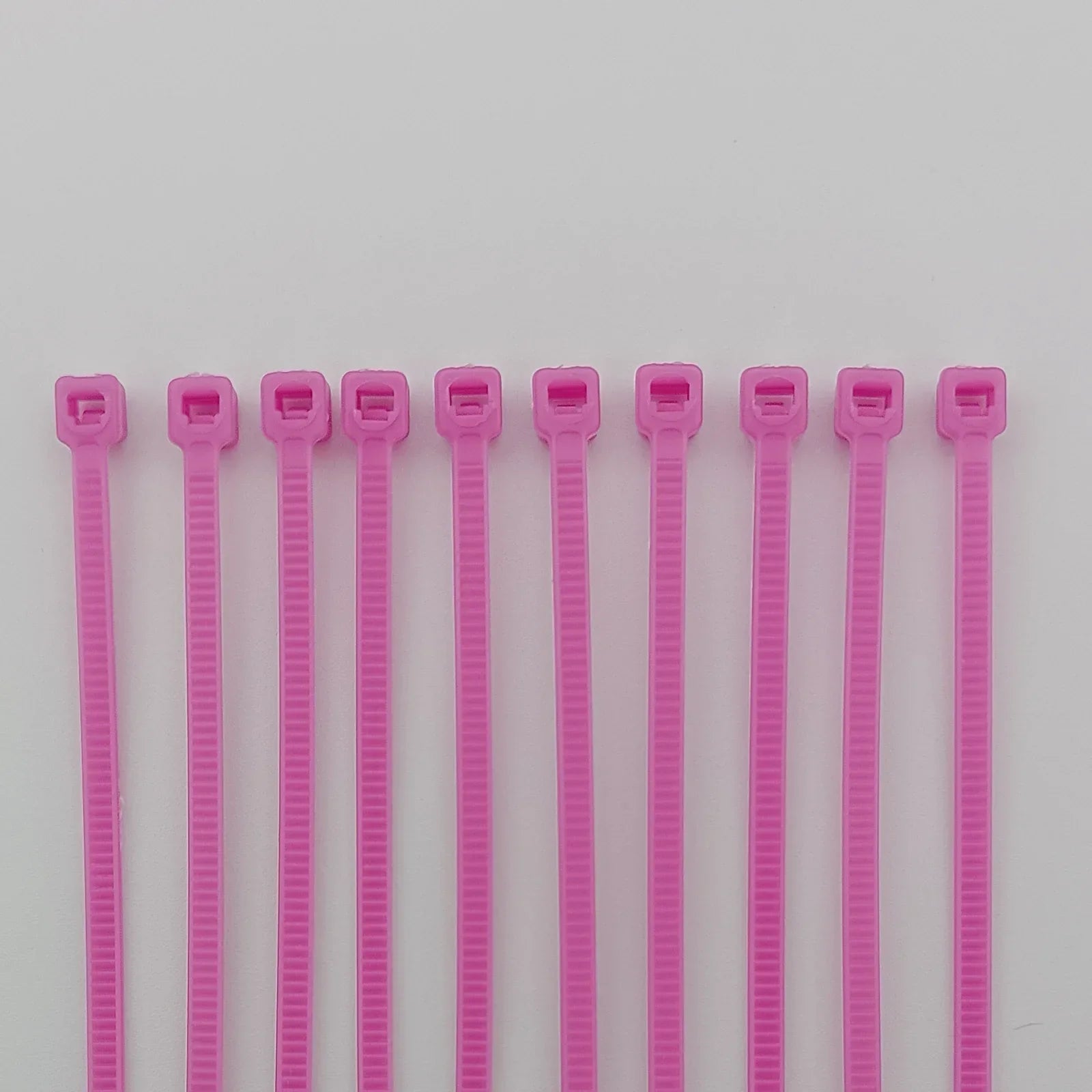 Pink plastic cable ties for wheelchair accessories and parts organization