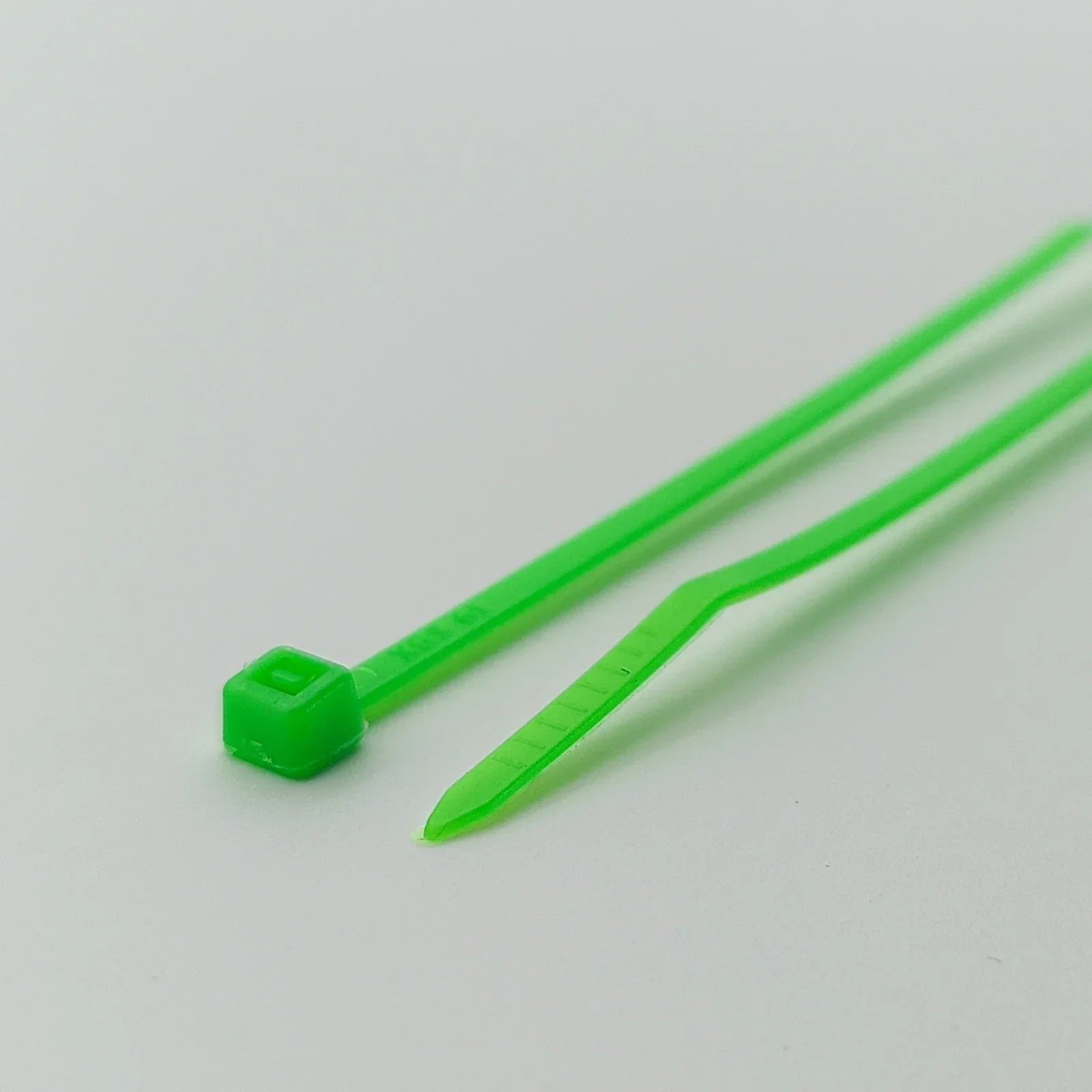 Bright green plastic cable ties for wheelchair accessories and parts organization