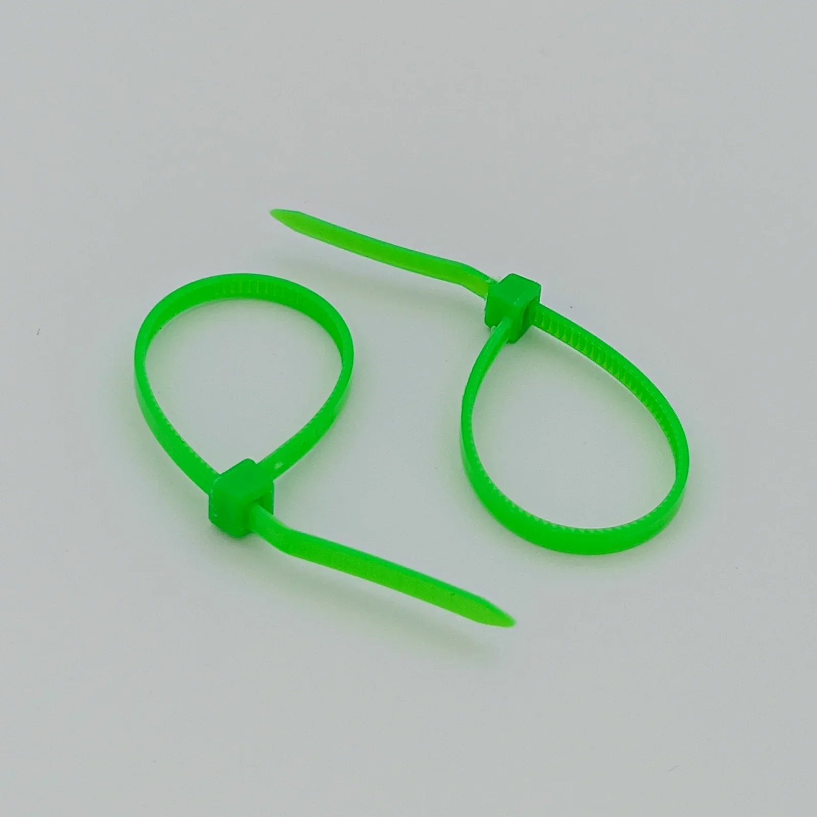 Bright green plastic cable ties for wheelchair accessories and parts organization