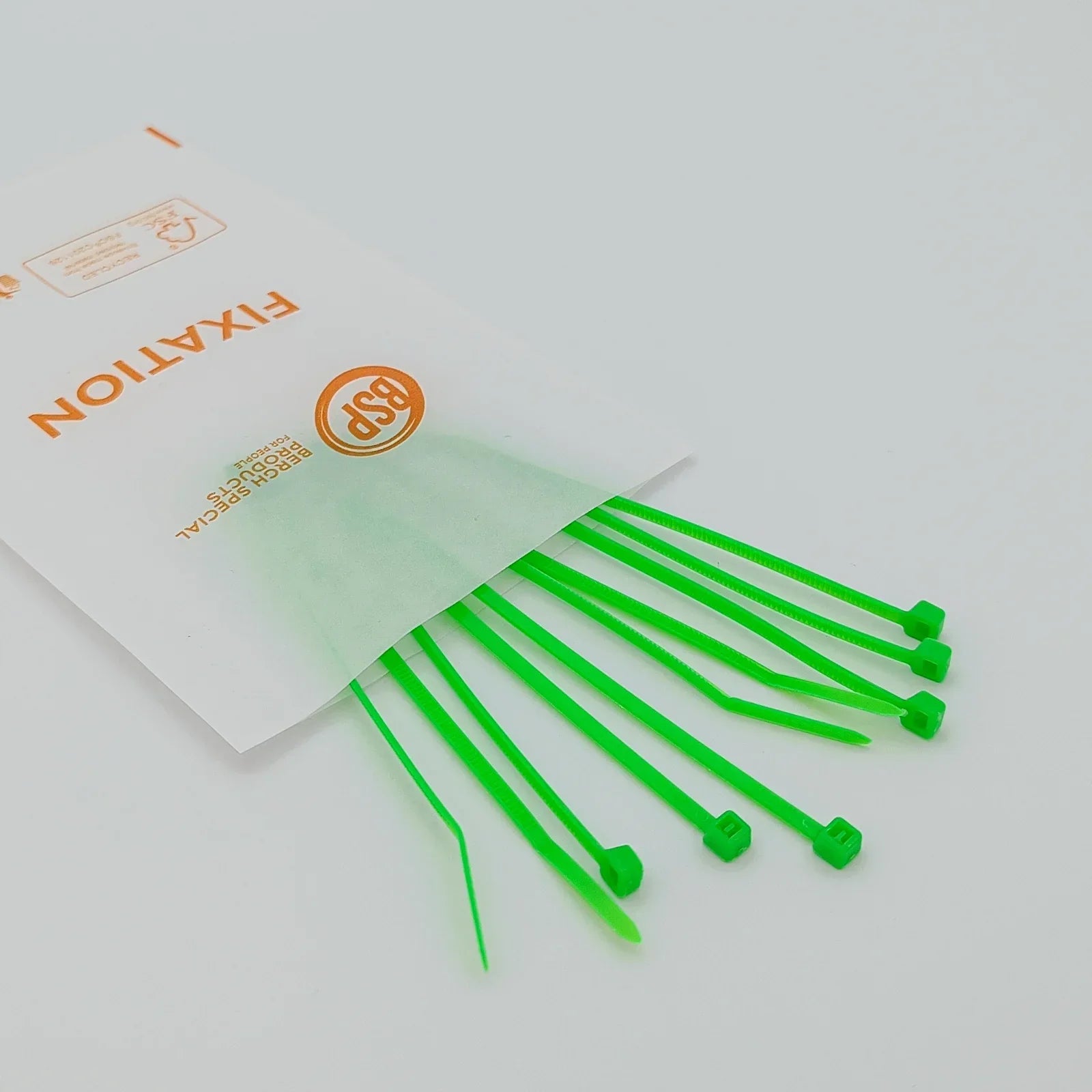 Bright green plastic cable ties for wheelchair accessories, packaged in clear BSP fixation bag