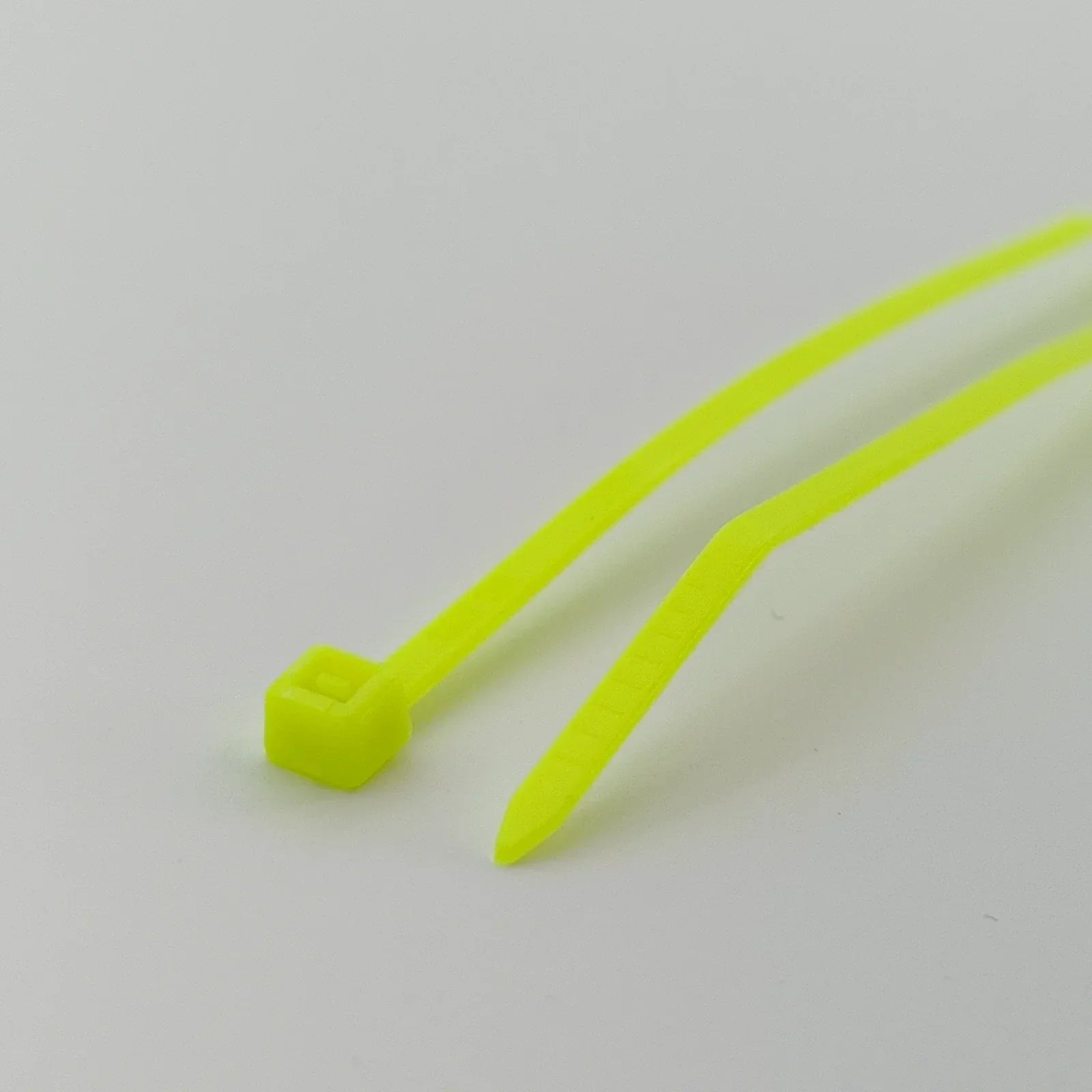 Bright yellow plastic cable ties for wheelchair accessories and parts organization