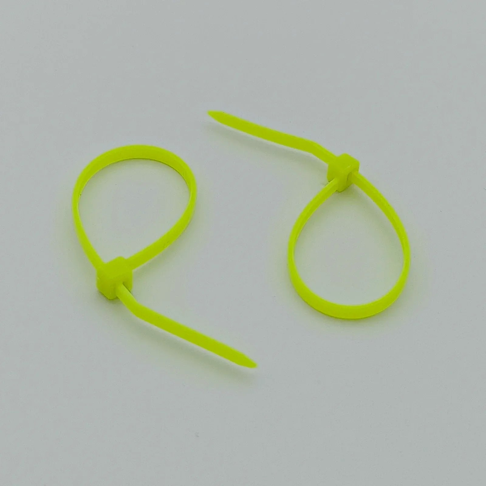 Bright neon yellow plastic zip ties for wheelchair accessories and parts organization
