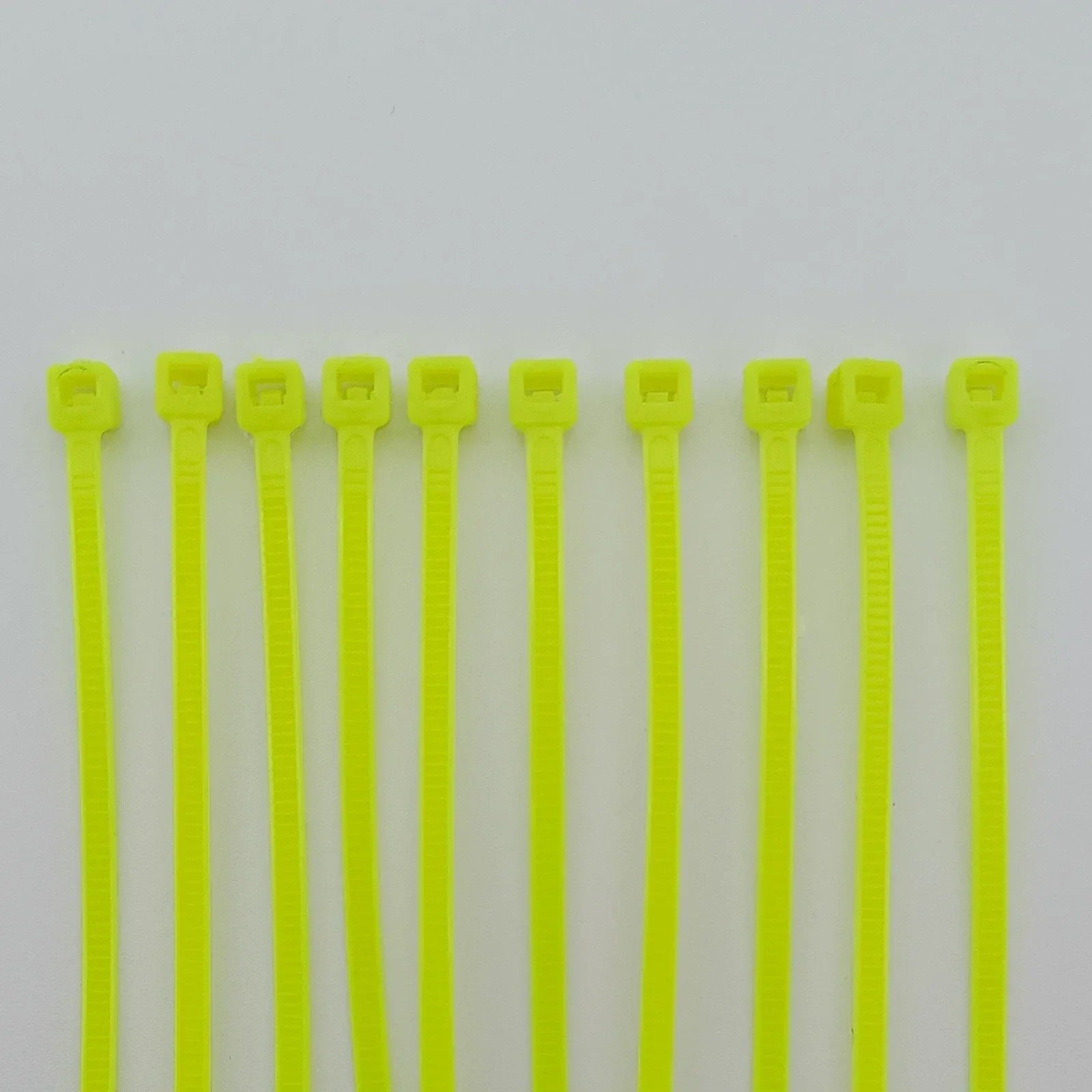 Bright yellow plastic cable ties for wheelchair accessories and durable equipment organization