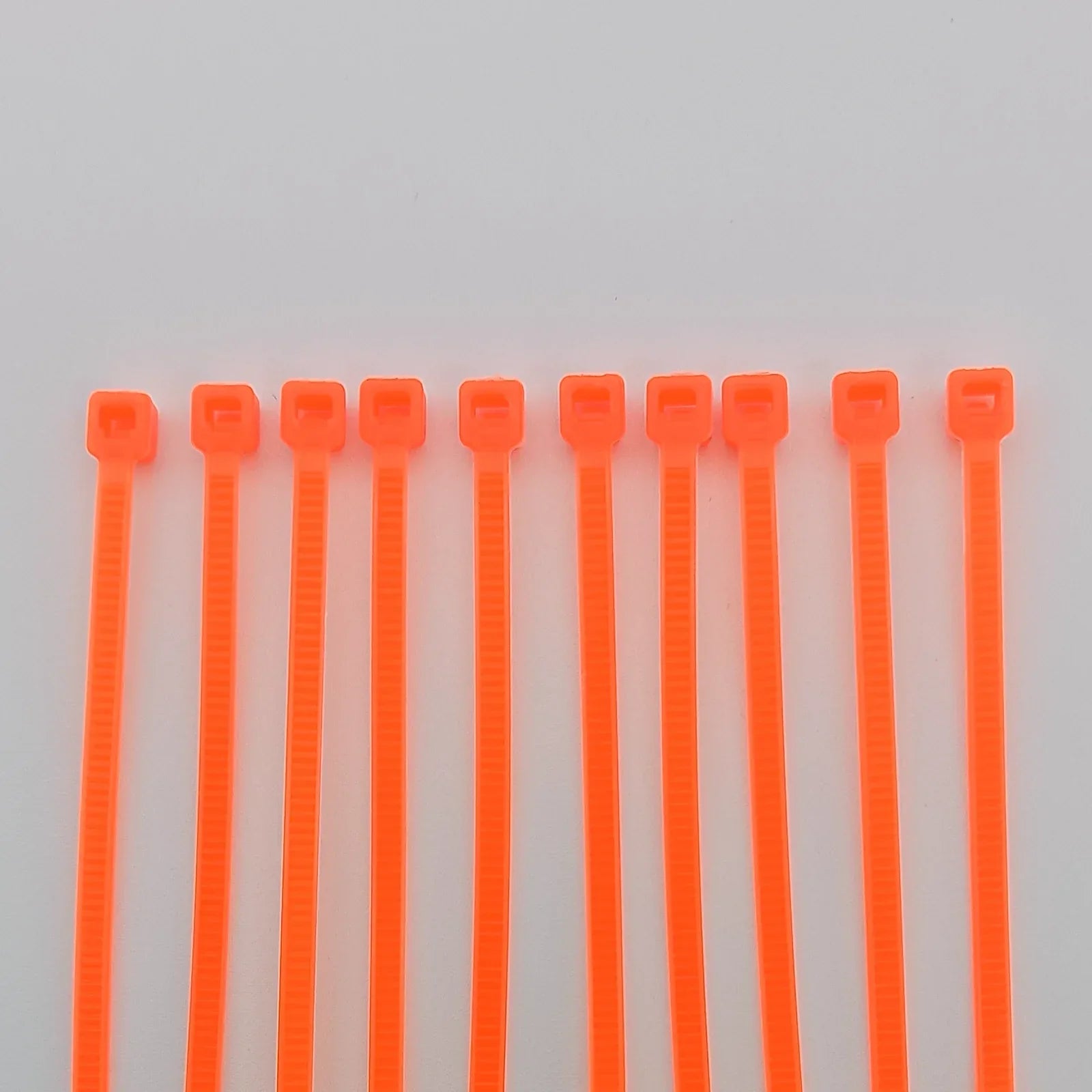 Bright orange plastic cable ties for wheelchair accessories and equipment organization