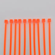 Bright orange plastic cable ties for wheelchair accessories and equipment organization
