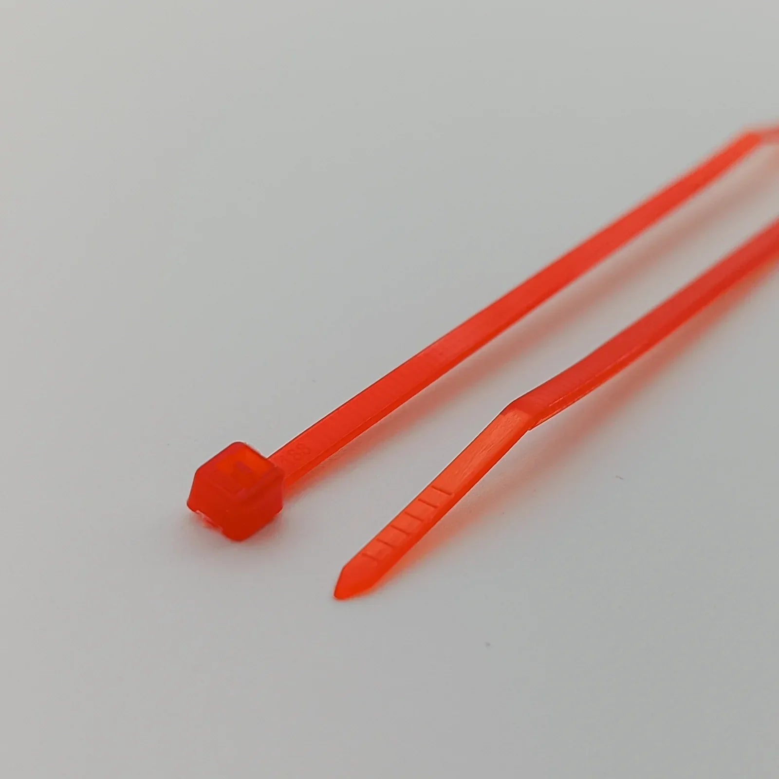 Bright orange plastic zip ties for securing wheelchair accessories and parts
