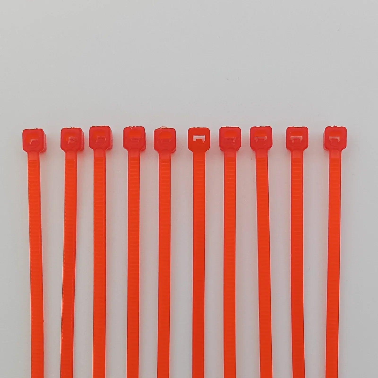 Bright orange plastic cable ties for wheelchair accessories and equipment organization