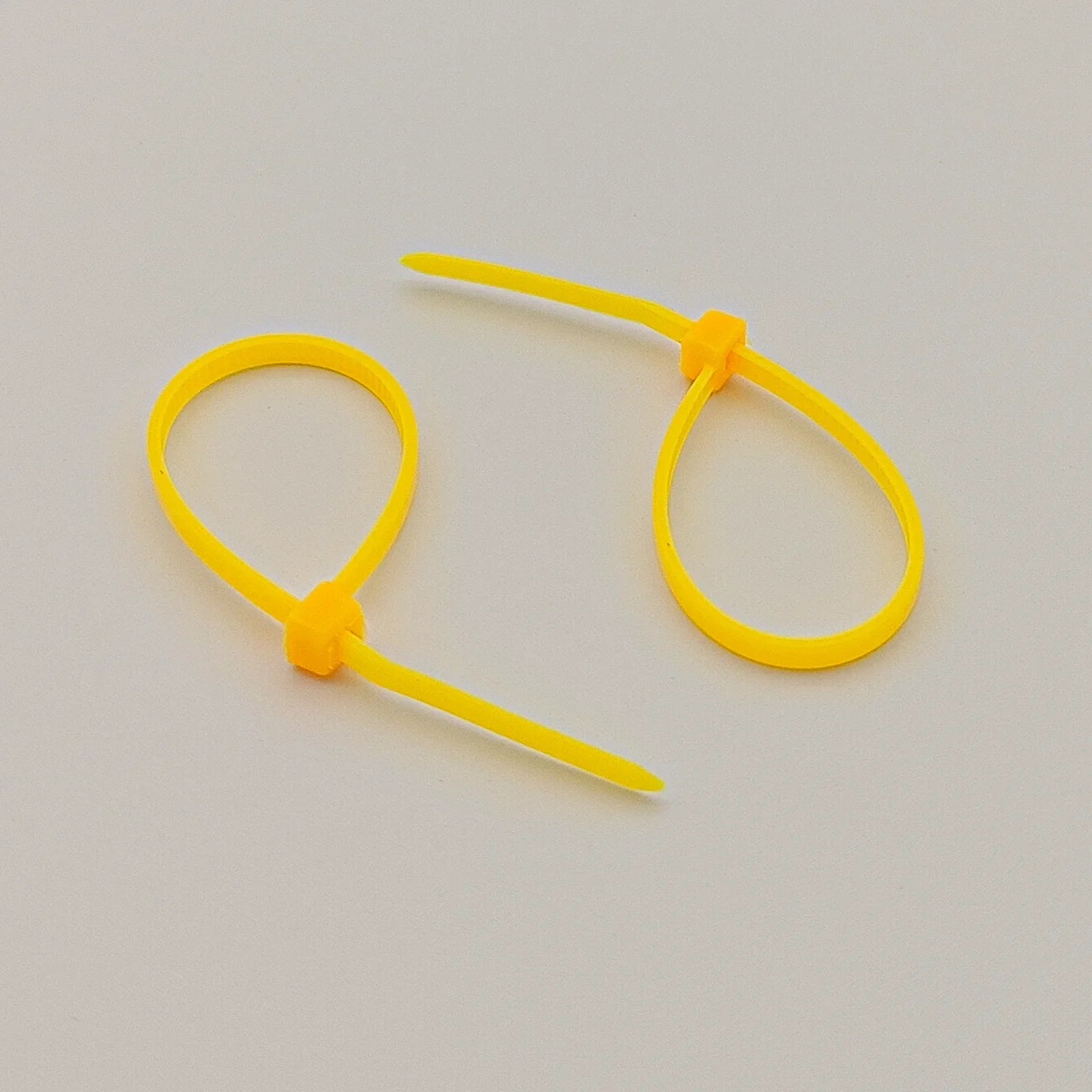 Bright yellow plastic cable ties for wheelchair accessories and parts organization