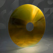Yellow wheelchair spoke guard with central hub hole on a neutral background